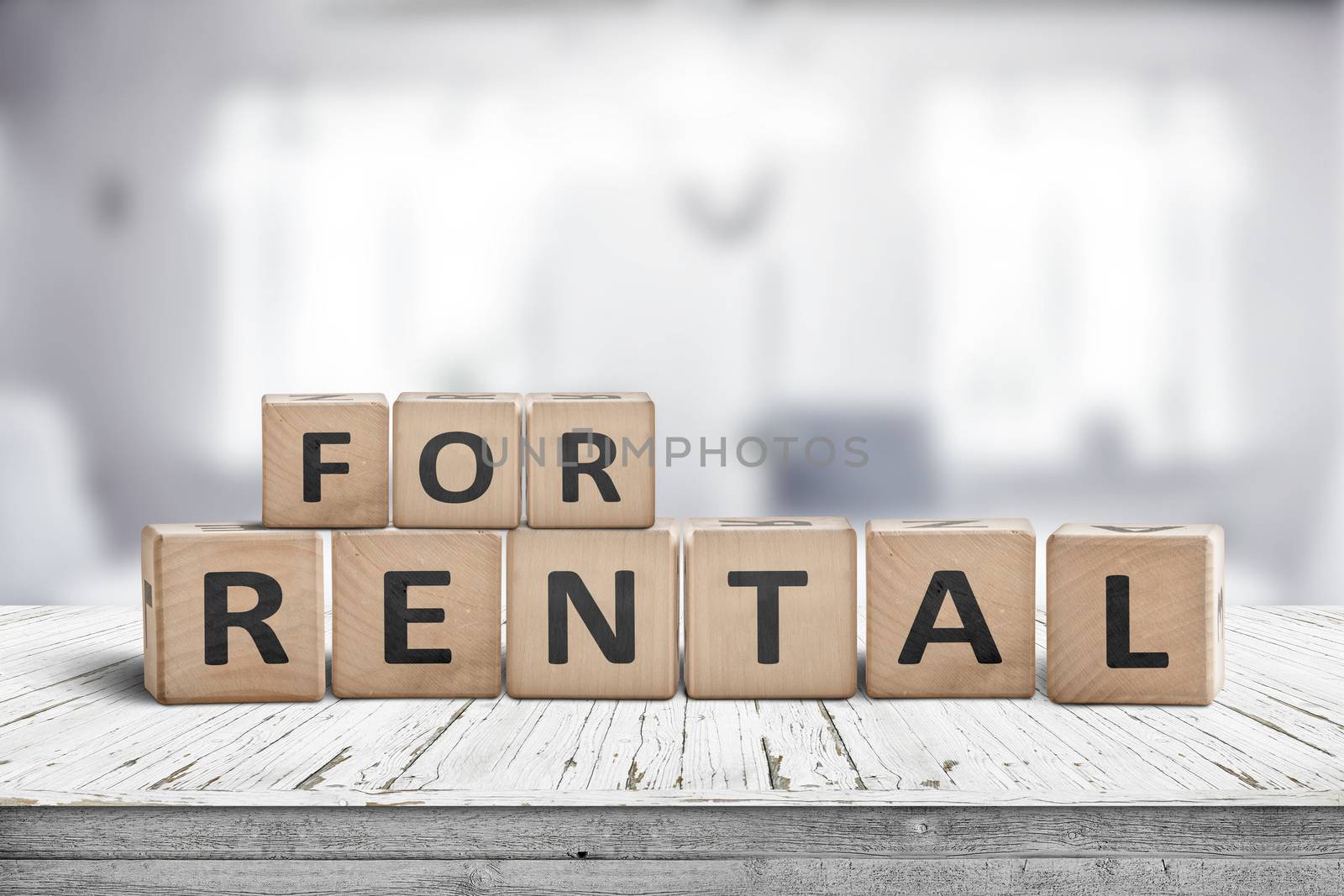 Sign with the text for rent on a desk in a living room