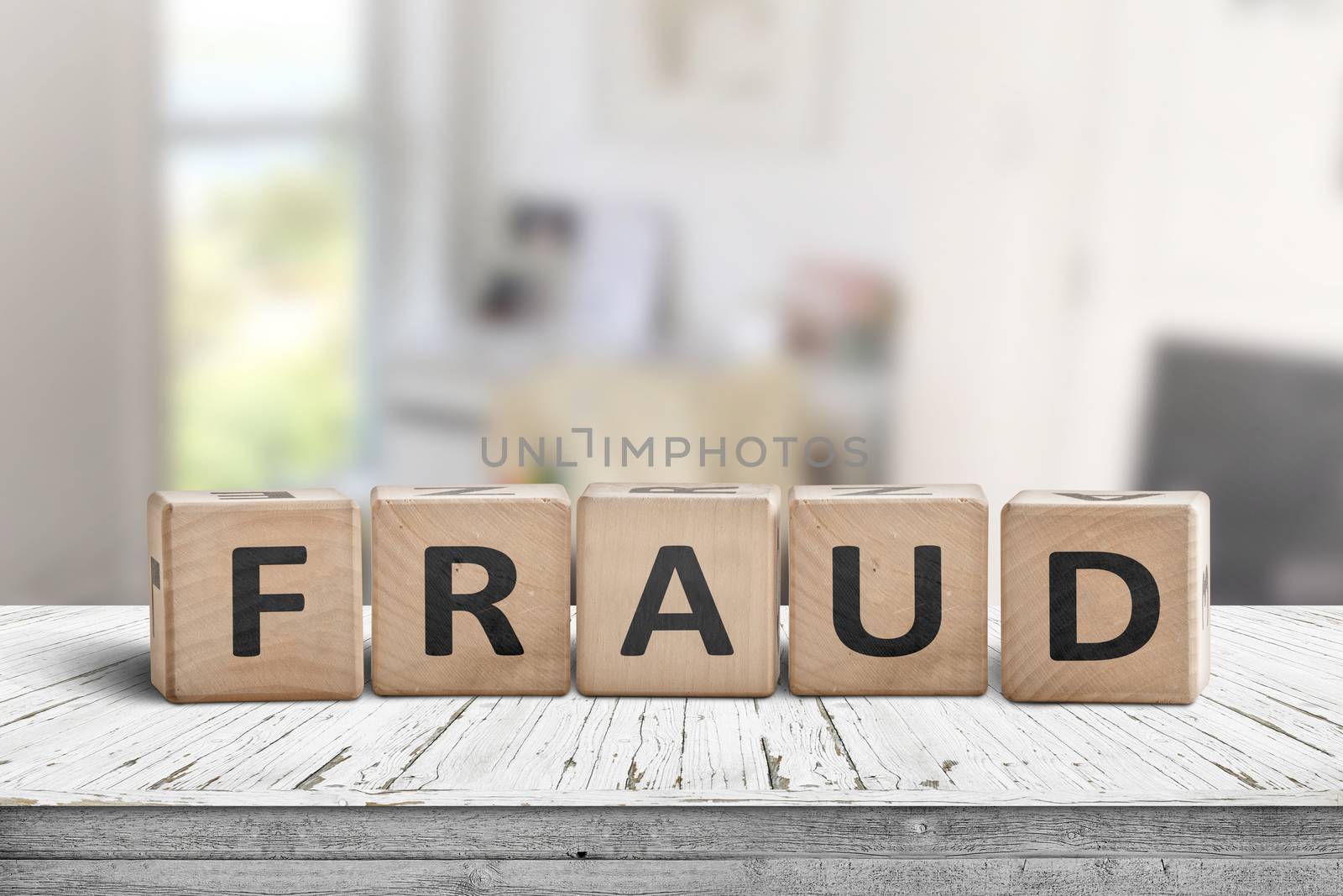 Fraud sign made of wooden blocks on a white desk by Sportactive