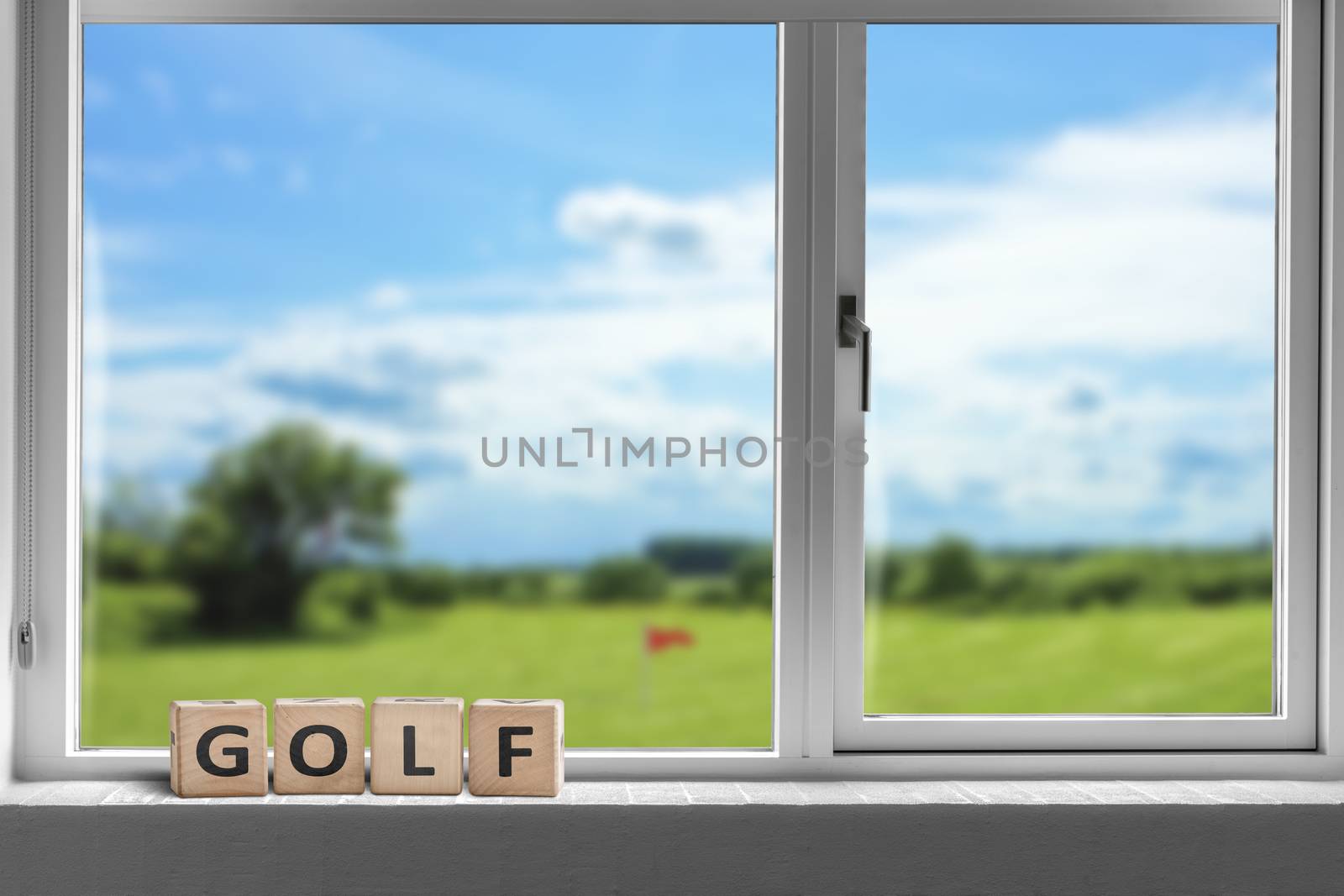 Golf sign in a window with a view to a golf course in bright daylight