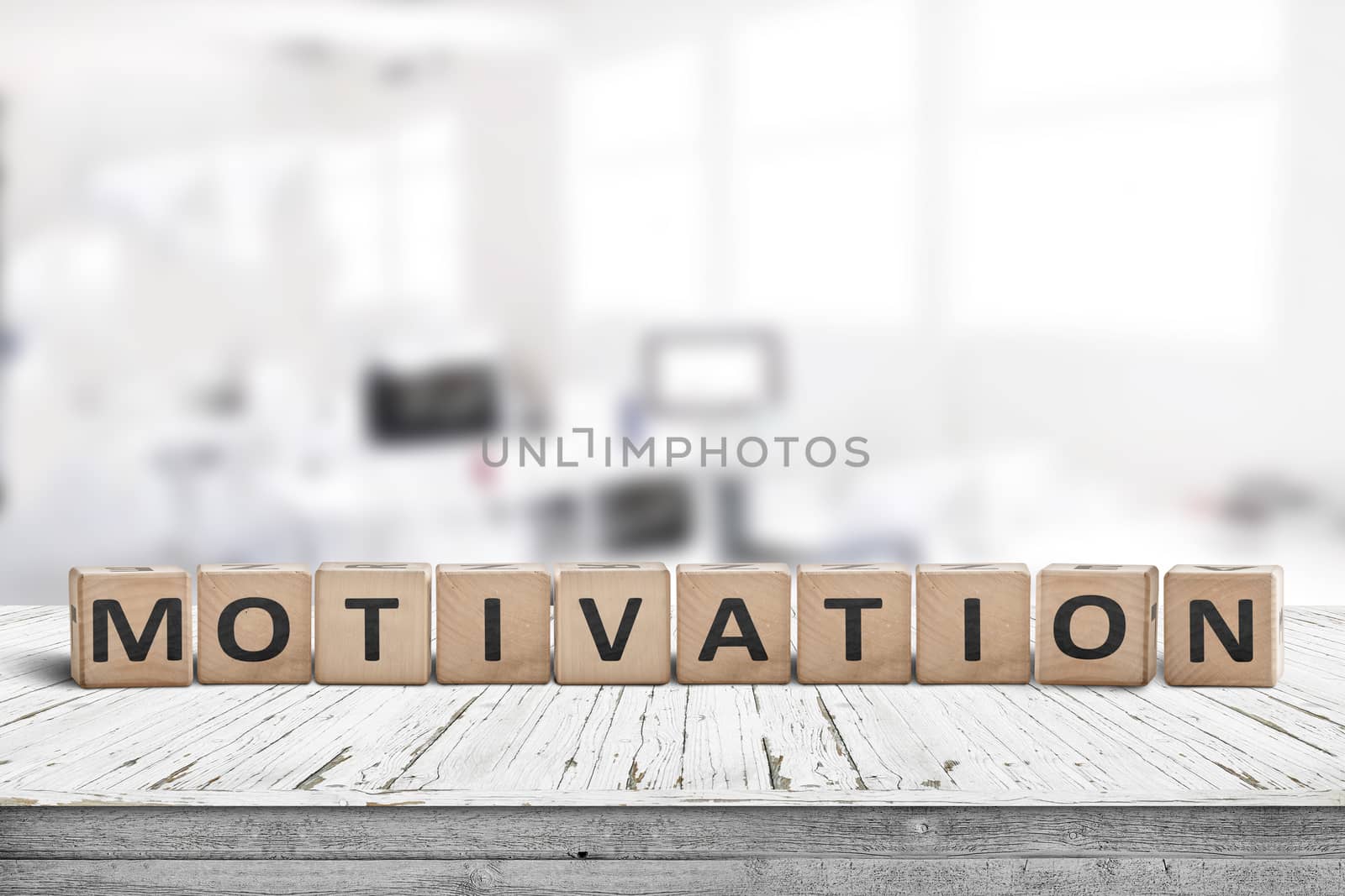 Motivation sign on a desk in a bright office in a business environment