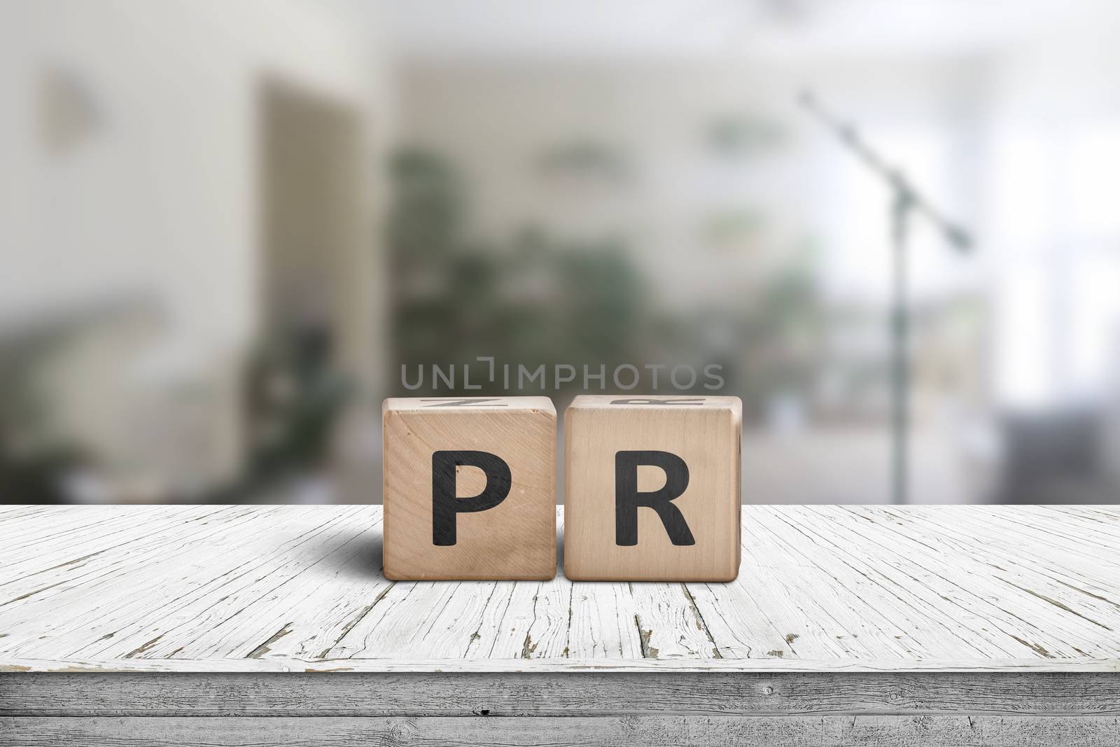 PR sign on a worn table in a bright room by Sportactive