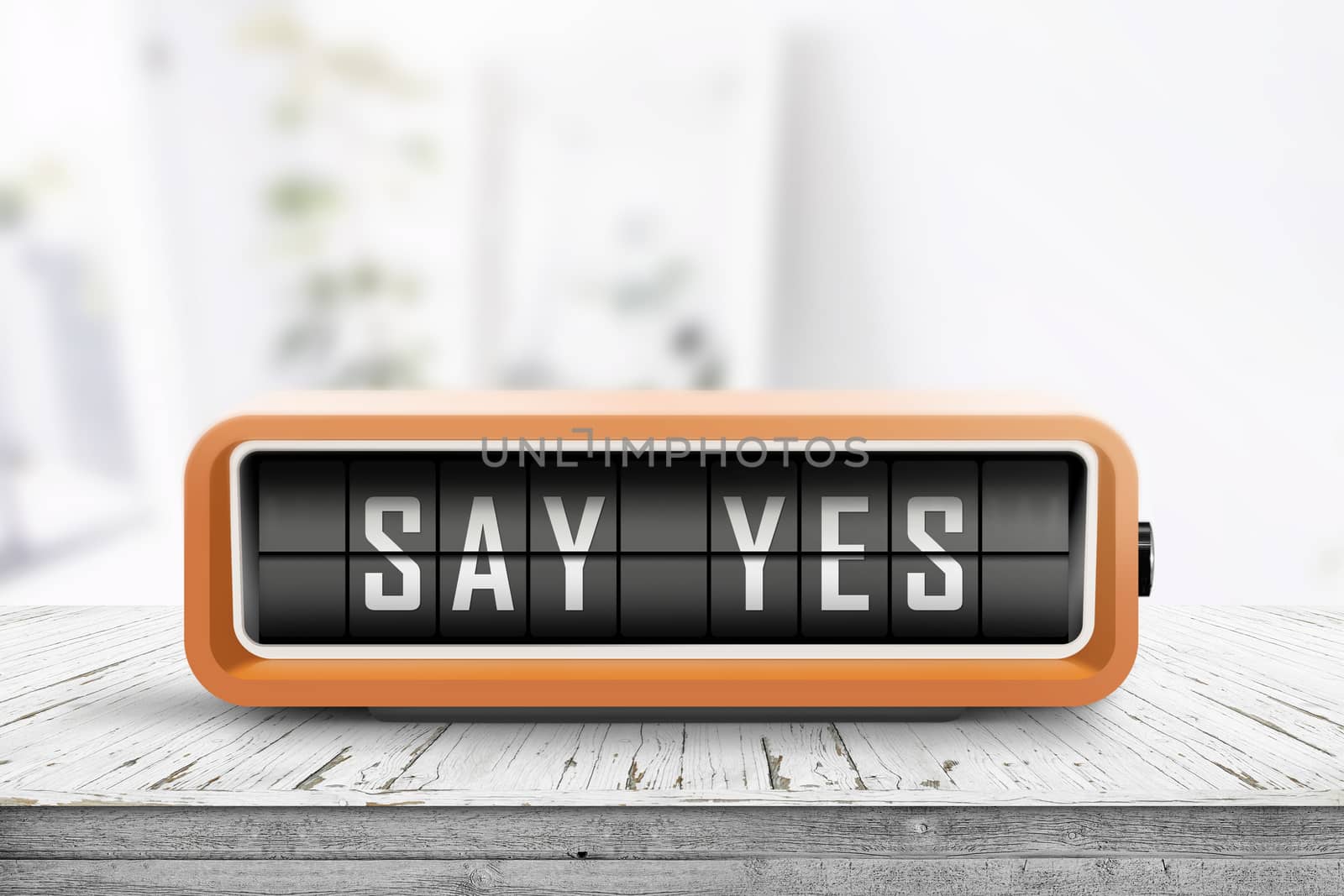 Say yes message sign on a wooden desk in a bright living room with a retro alarm clock