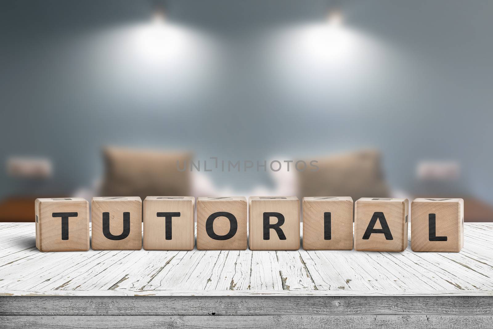 Tutorial sign on a wooden table in a room with lights on a blurry background