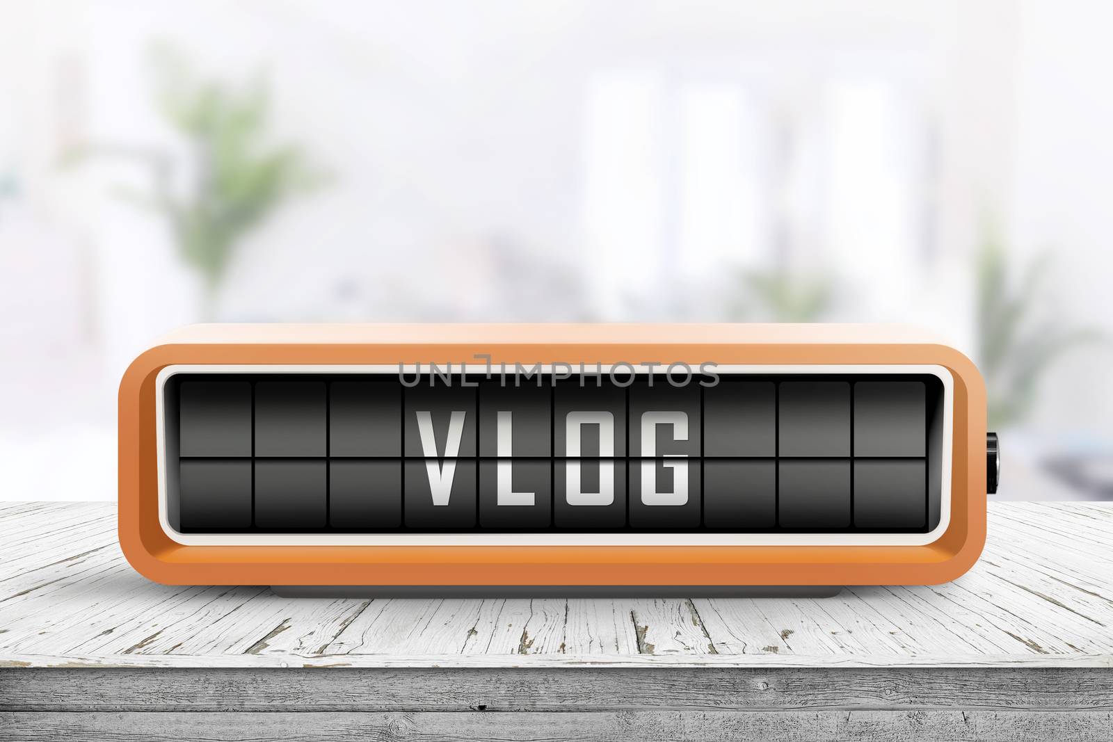 Vlog word written on a retro device in orange color in a bright room