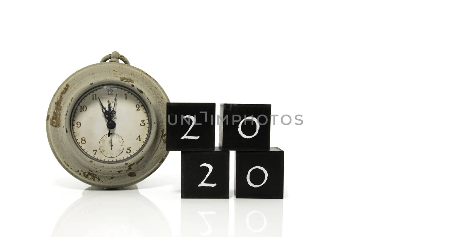 2020 New Years eve celebration. Minutes to midnight on an old watch isolated on white background