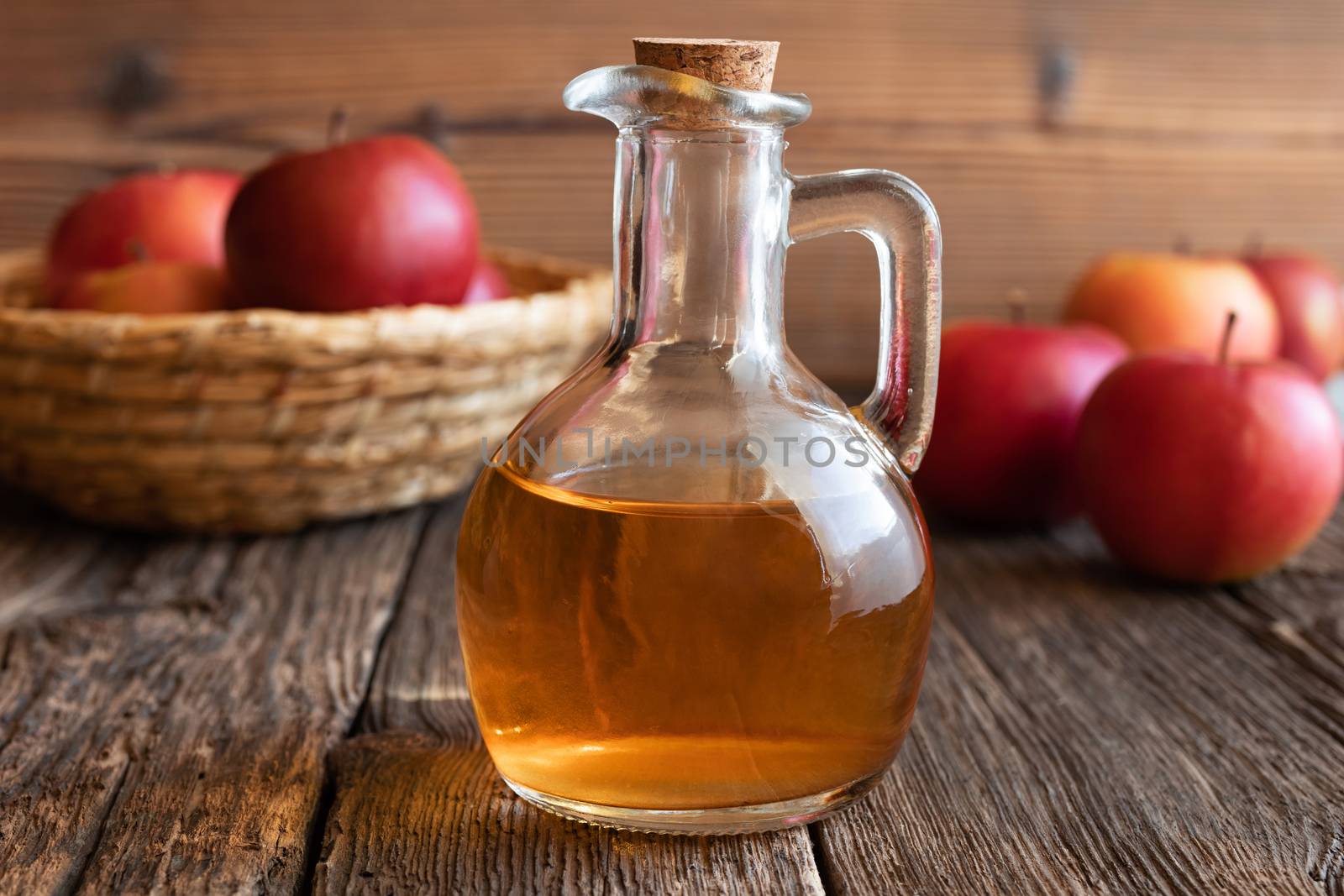 A bottle of apple cider vinegar with fresh apples by madeleine_steinbach