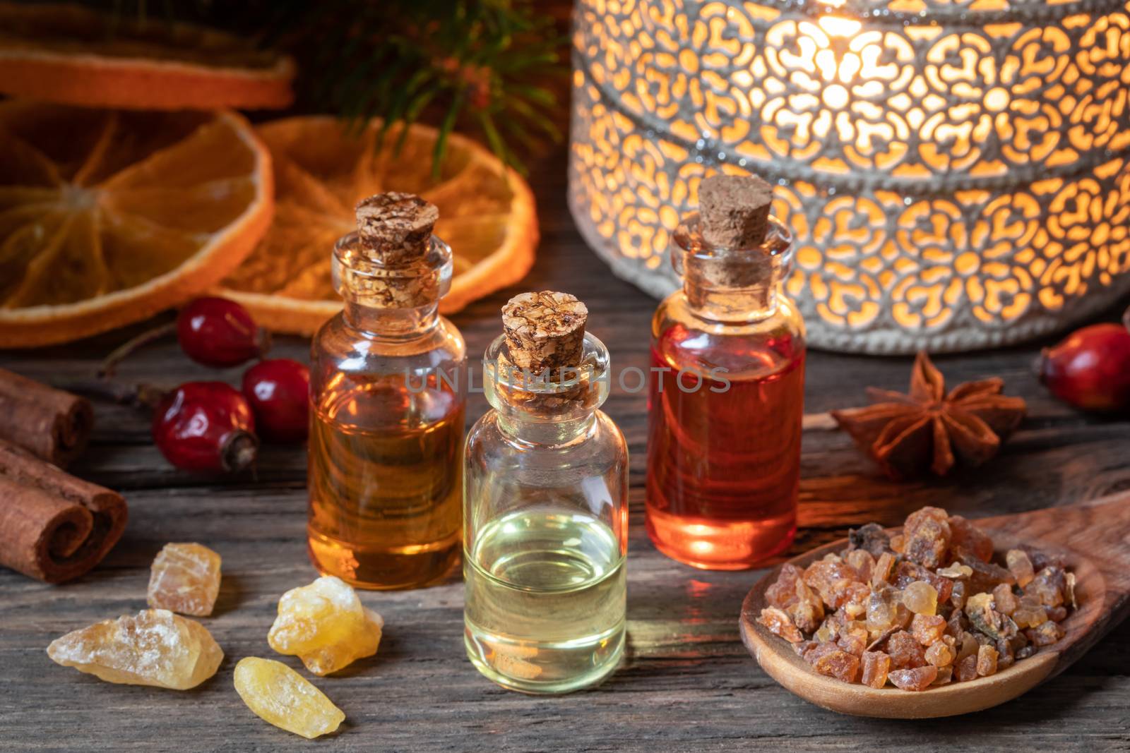 Christmas collection of essential oils with frankincense, myrrh, winter spices and dried orange slices