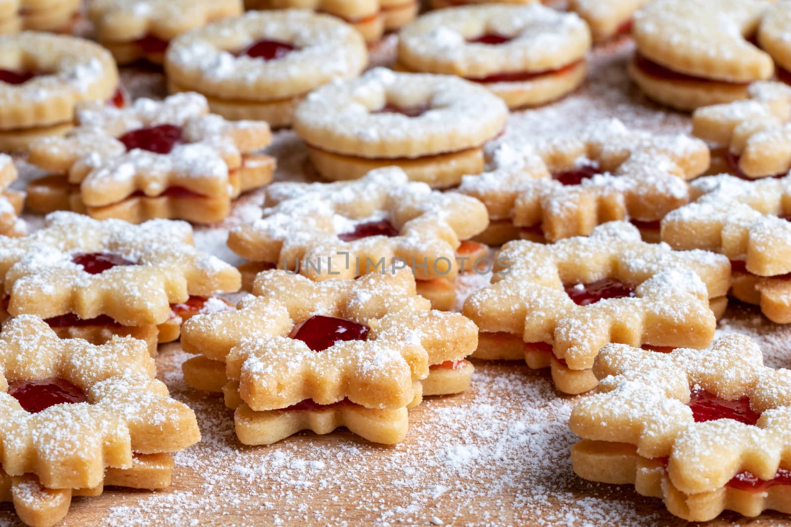 Traditional Linzer Christmas cookies filled with strawberry jam and dusted with sugar