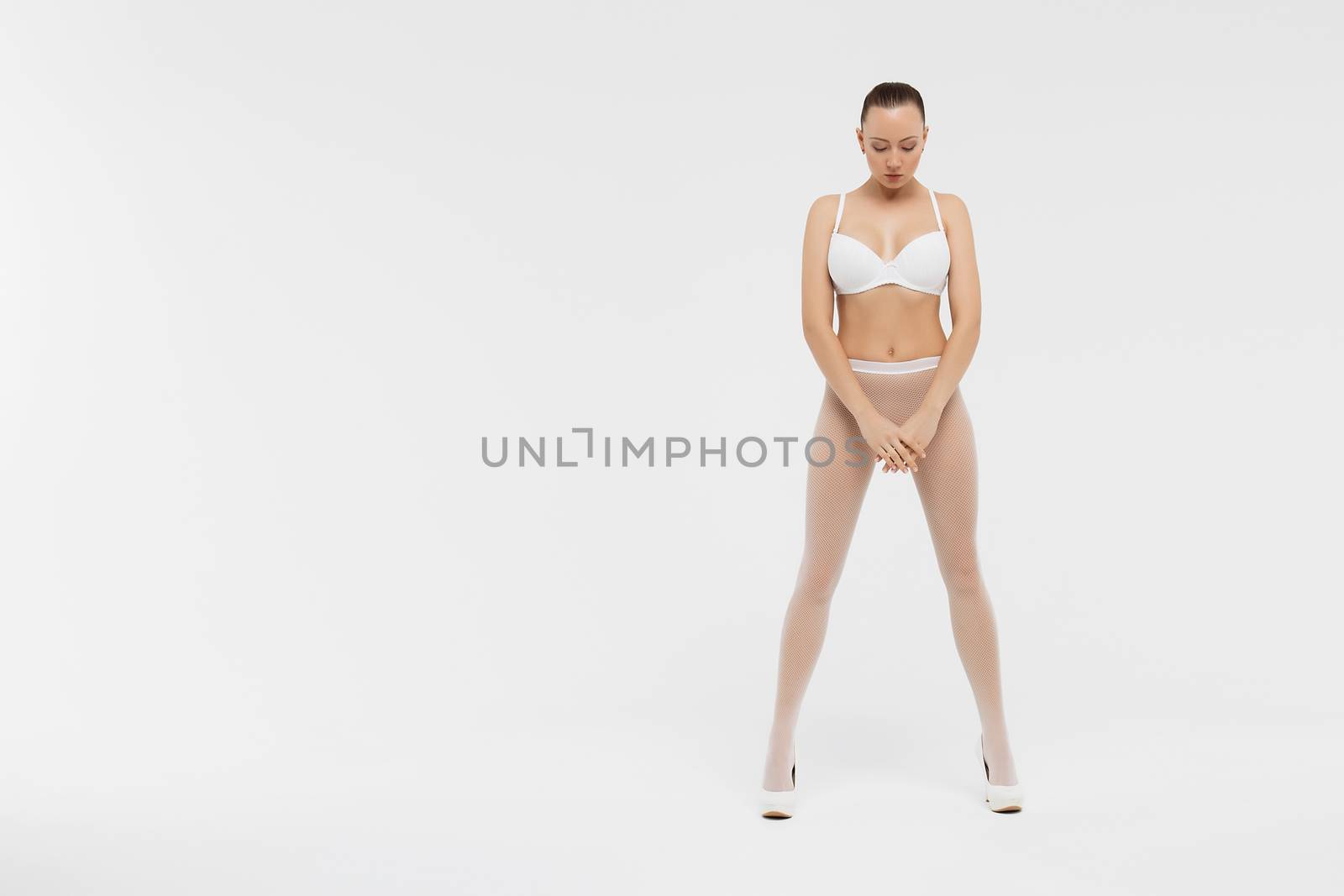 Beautiful sexy slim woman on white background by 3KStudio