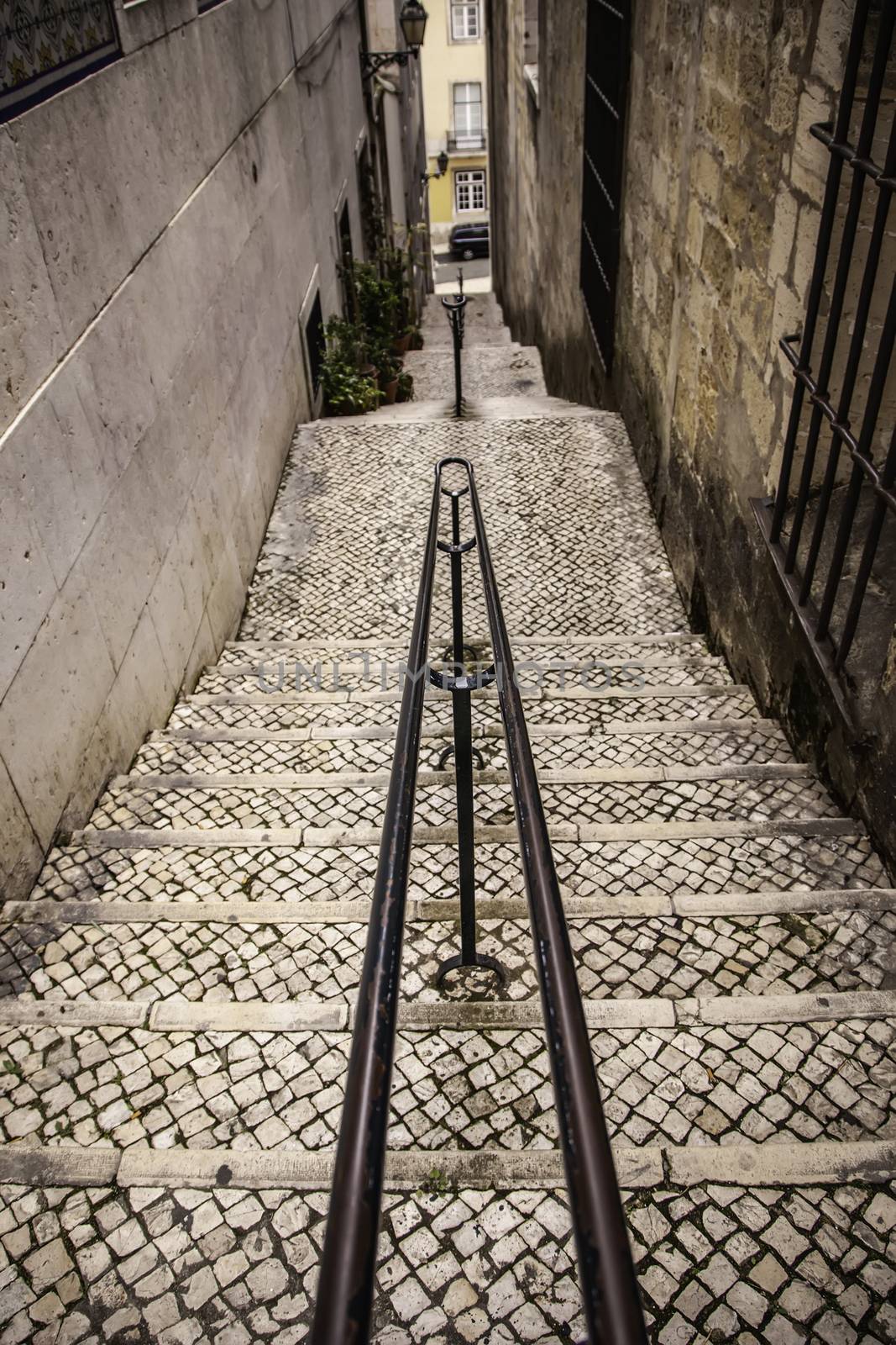 Old stone stairs in Lisbon, detail of stairs in an old street in an old neighborhood in Portugal