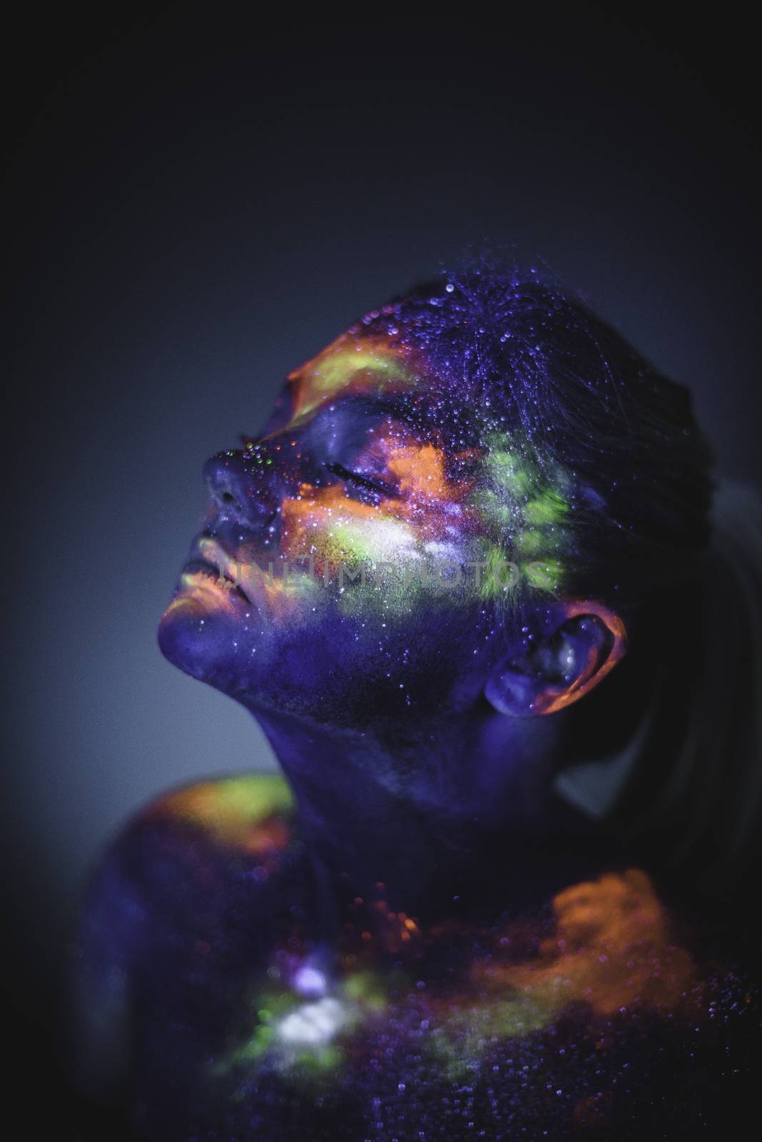 Portrait of a girl painted in fluorescent UV colors. by Multipedia