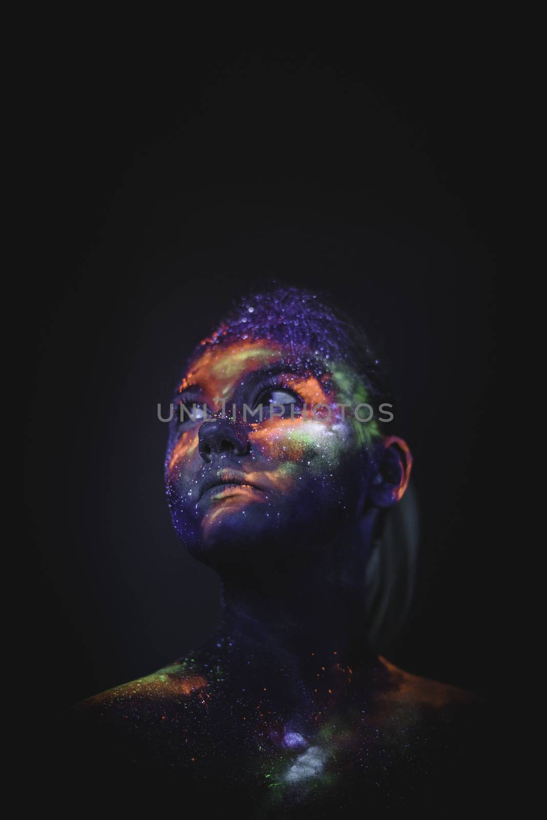 Conceptual shot of light and shine fluorescent colors young girl's face