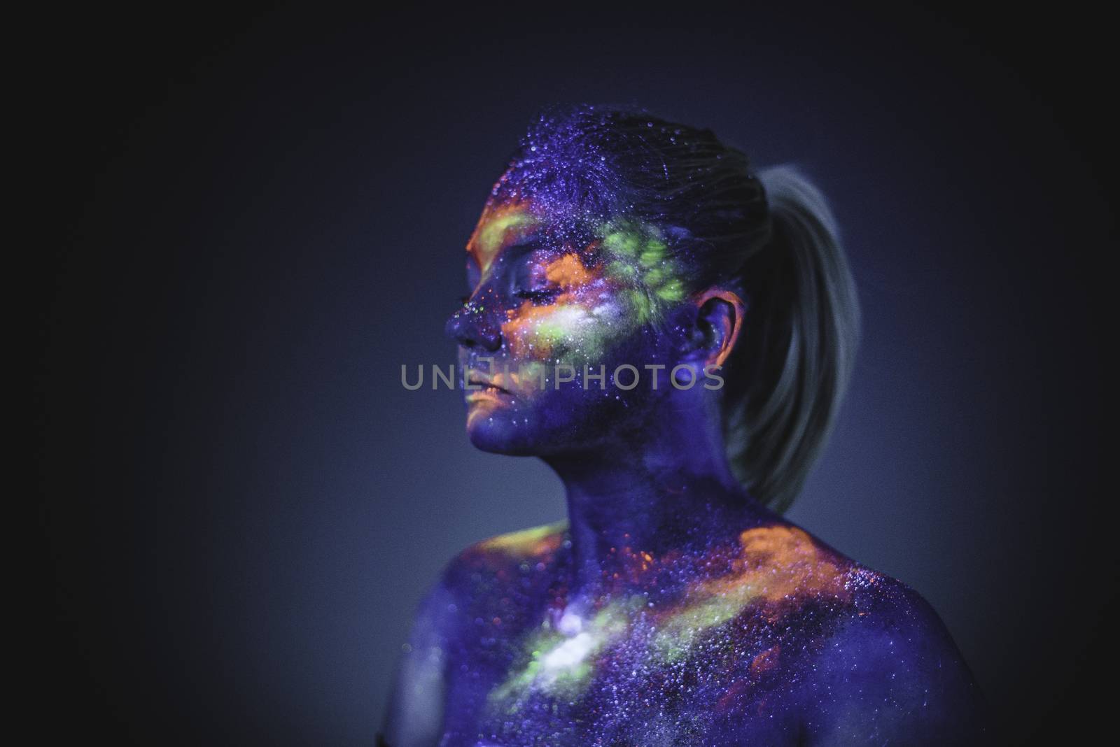 Conceptual shot of light and shine fluorescent colors young girl's face