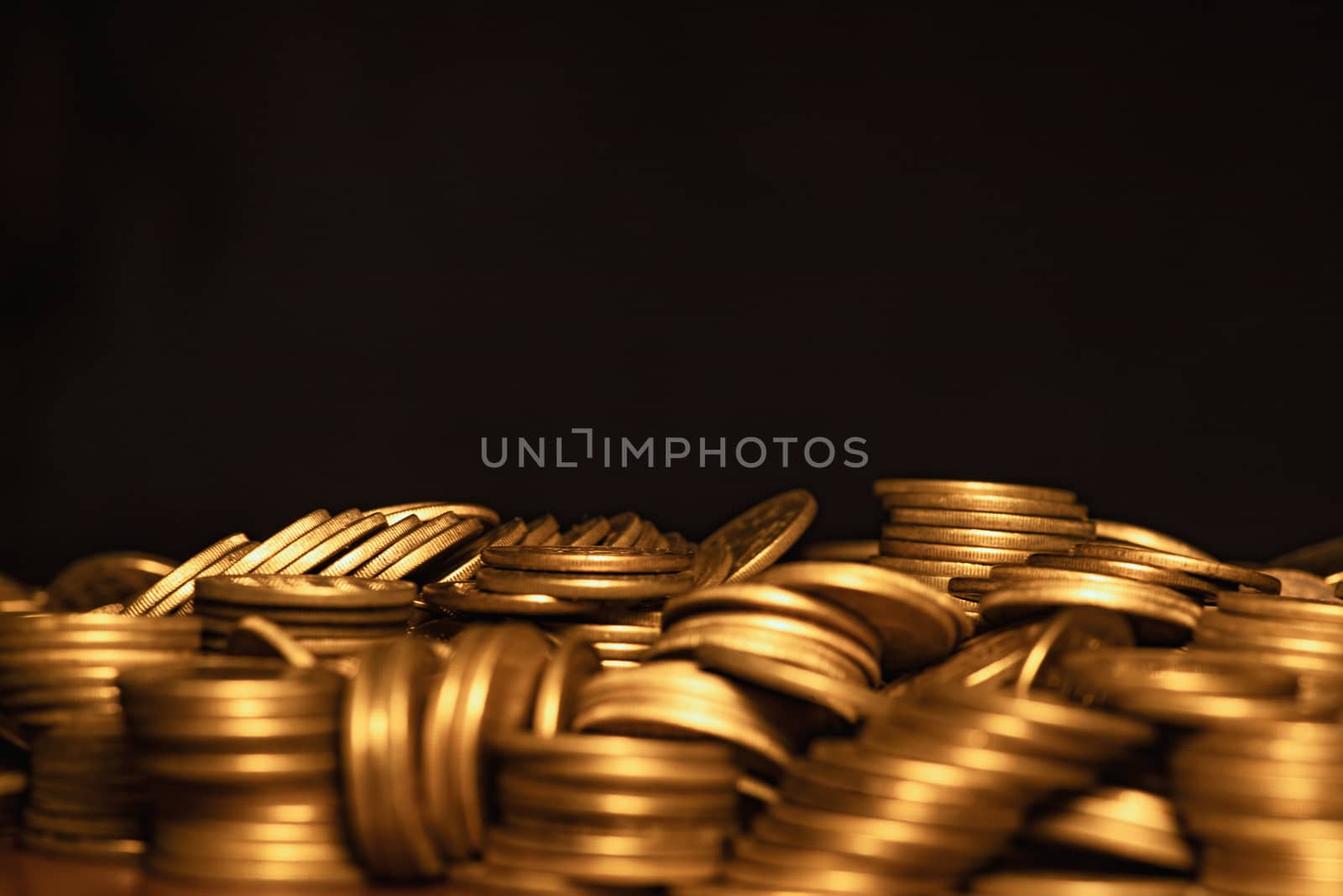 A lot of coins, selective focus.Front view of stacks of Euro coins.Concept photo.Coins close-up on the table. Simple and minimalistic design .