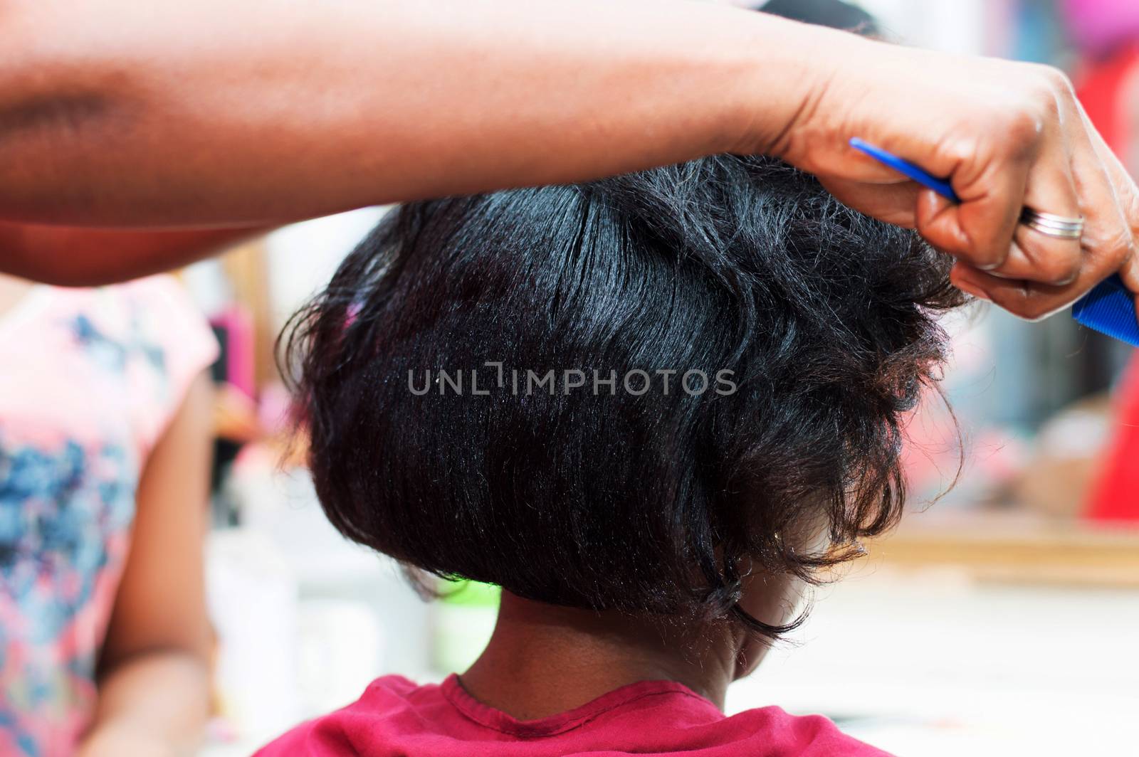 The hairdresser creates a model of hair on the head of her clent. 
