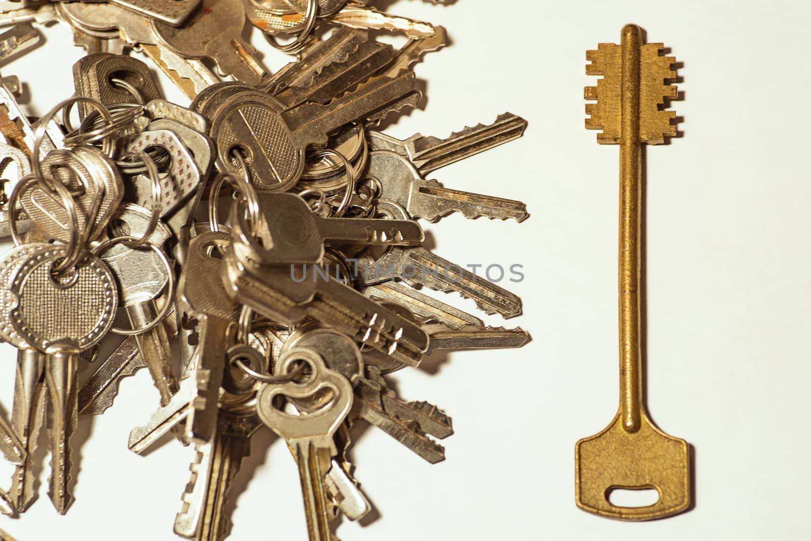 Many keys of different sizes. Keys on a white background, close-up. Selective focus, soft focus.