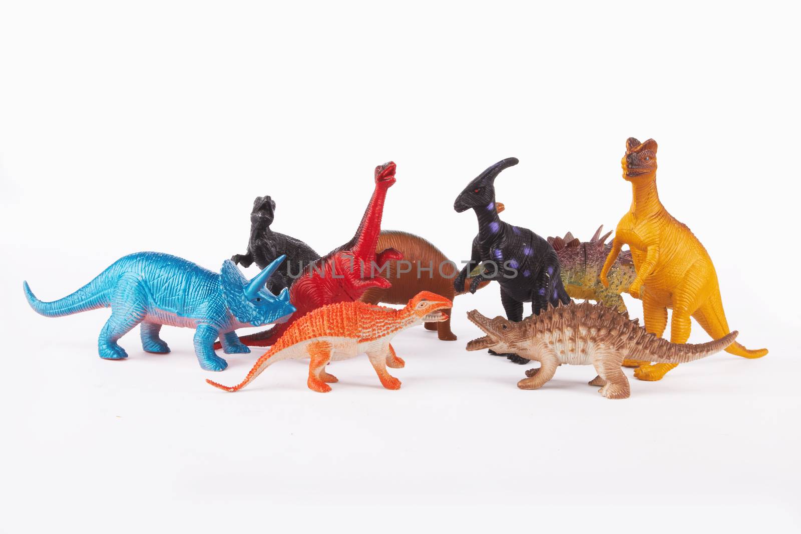 Toy dinosaurs on white background 