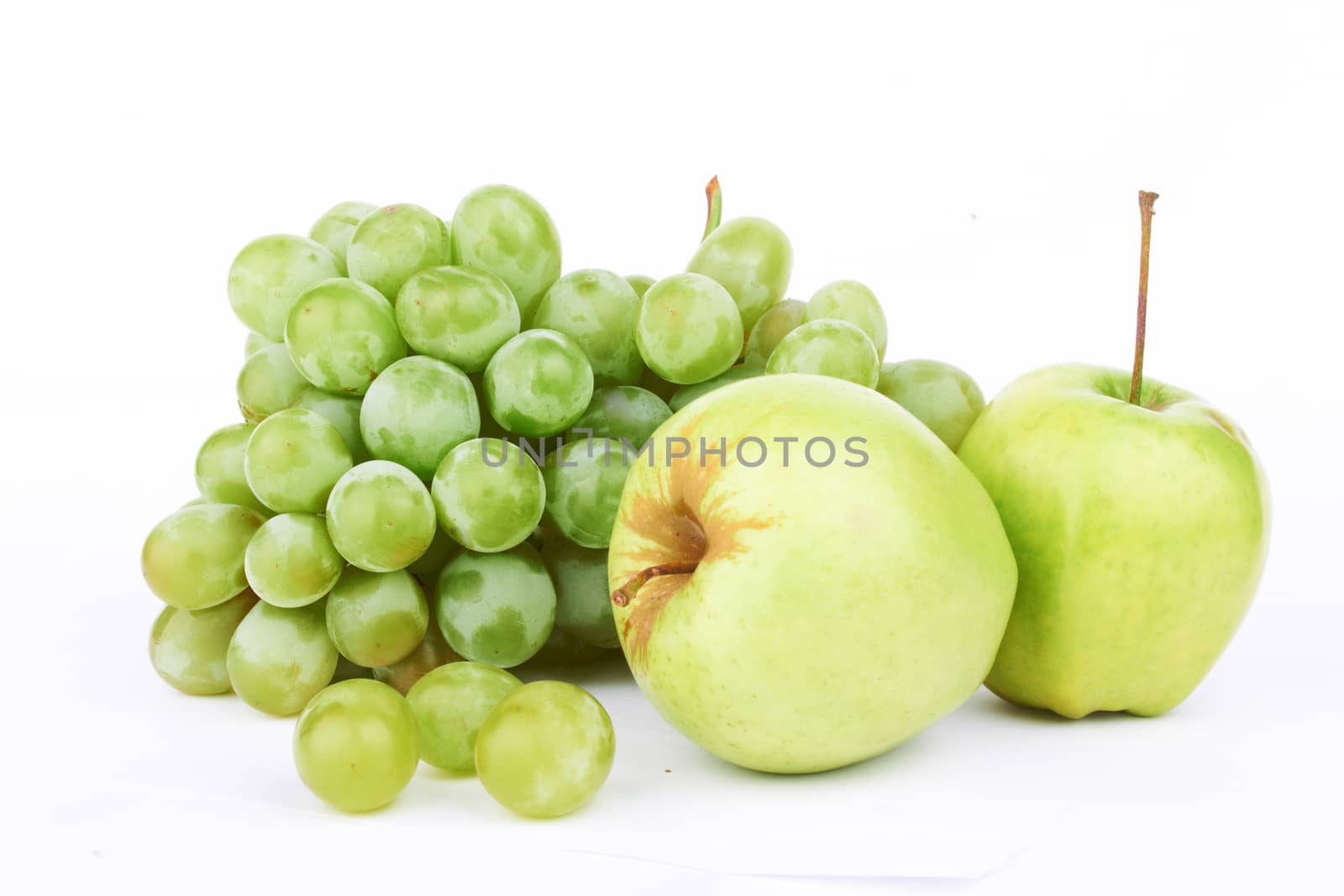 Grapes and two apples on a white background