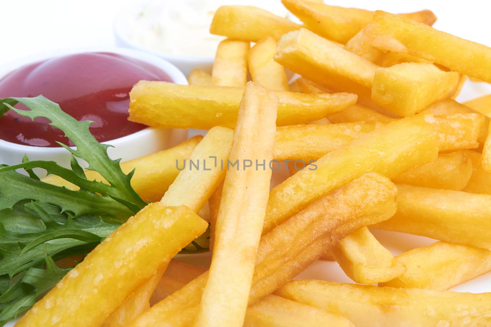 French fries with ketchup closeup over white