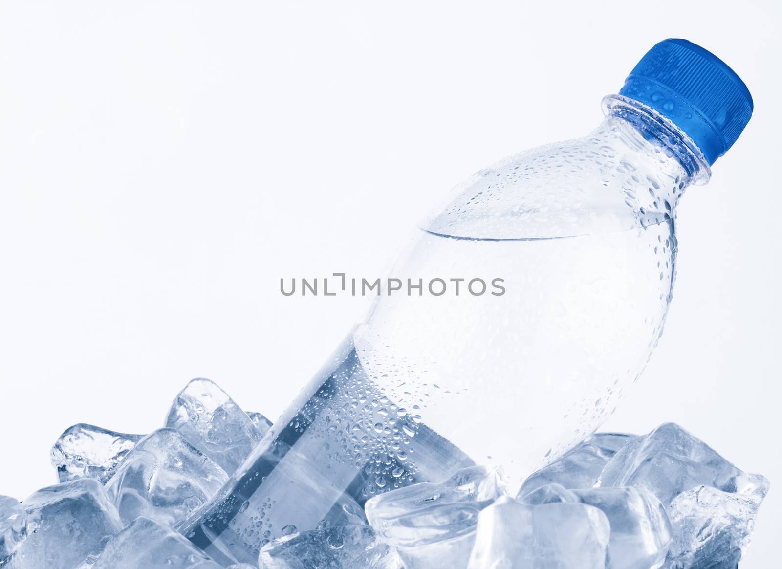 Water bottle in ice on white background 