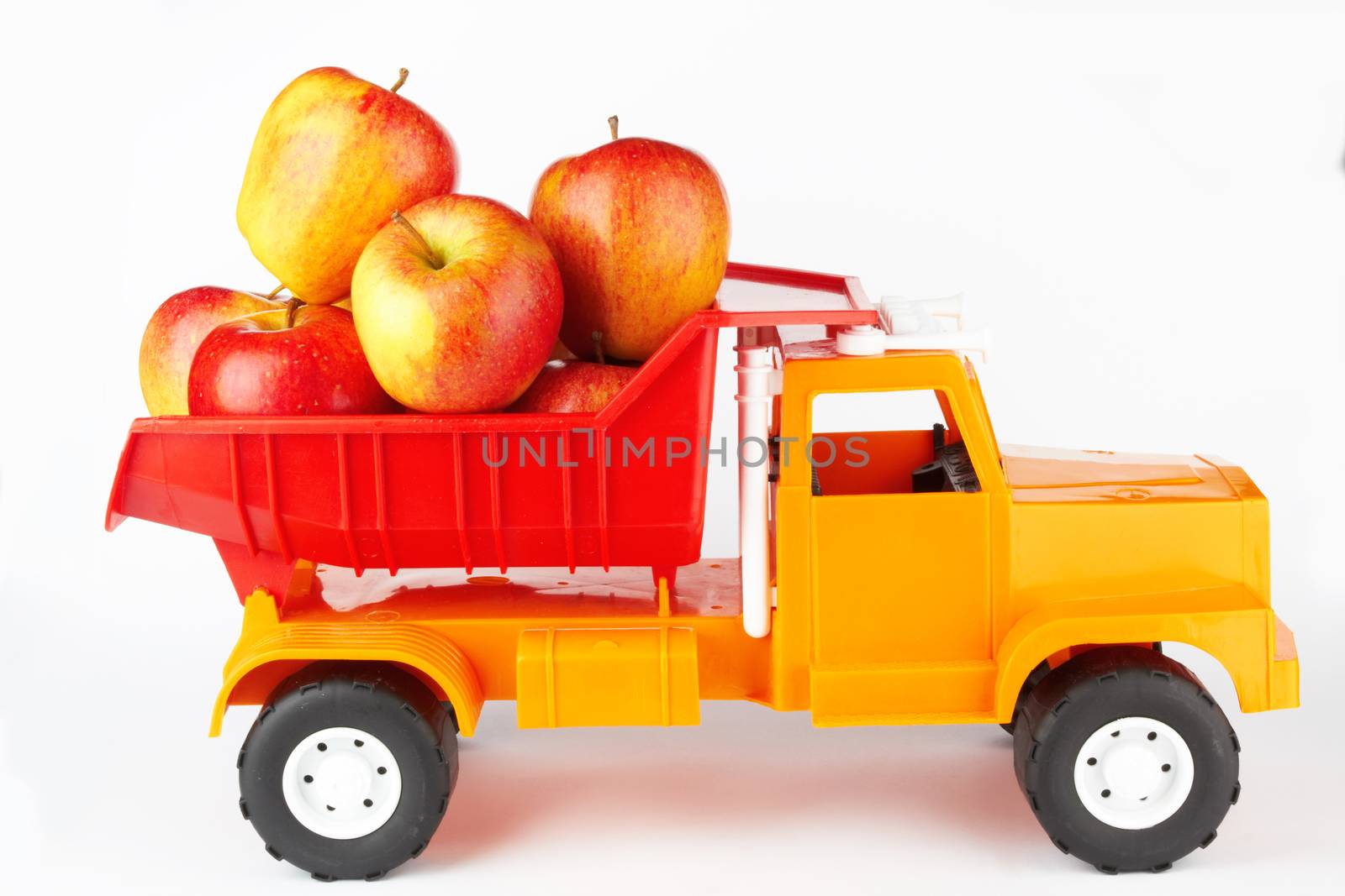 toy lorry with apple on white