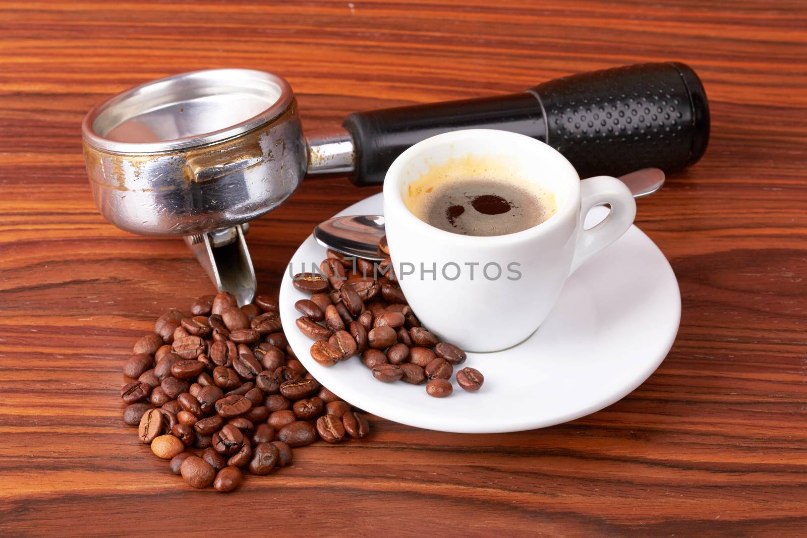 cup of coffee with coffee beans on wooden background