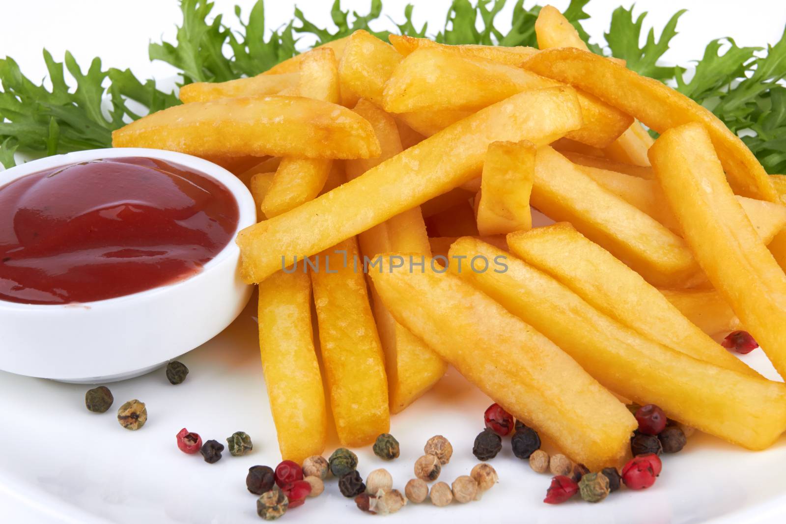 French fries with ketchup closeup over white 