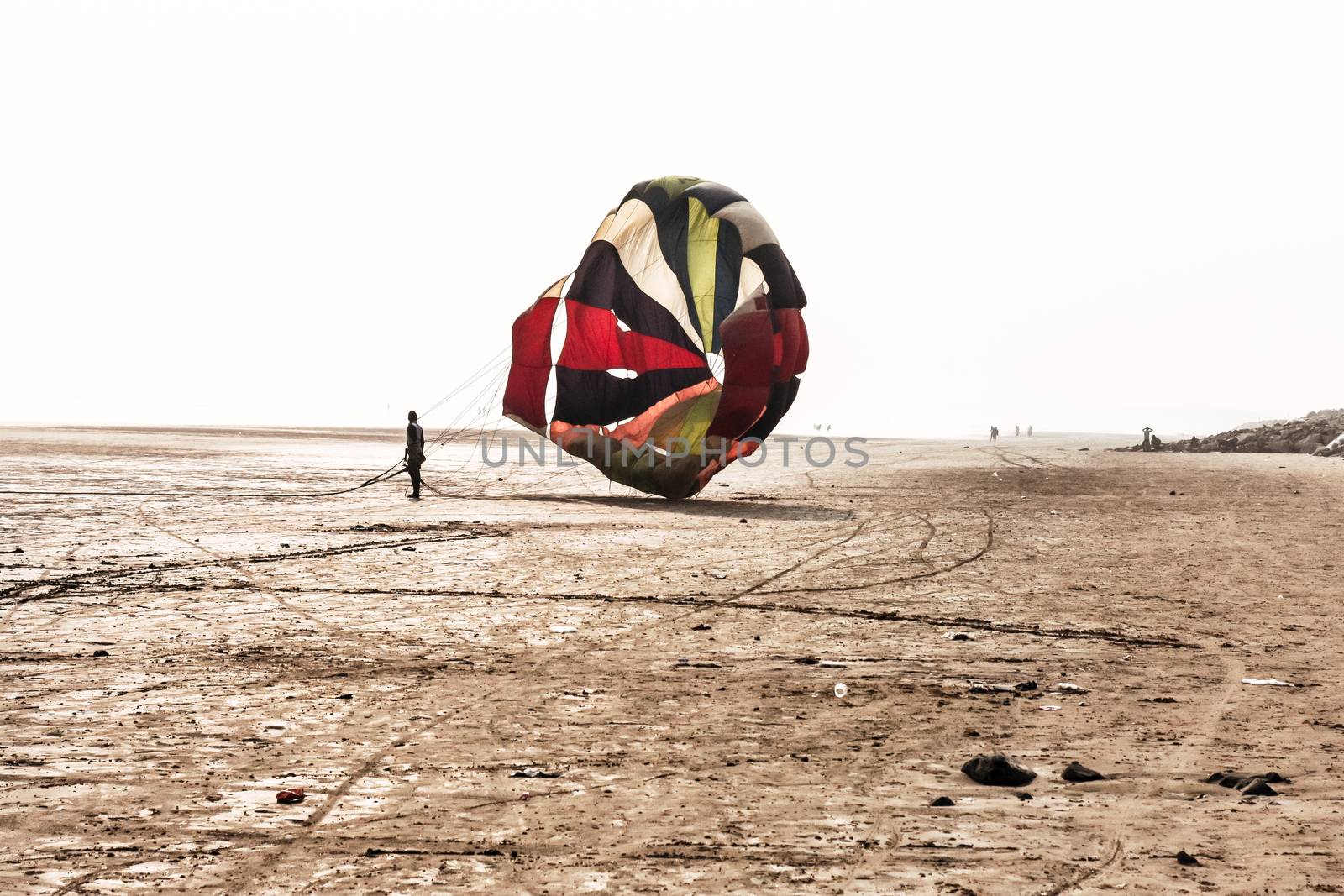 Shadow of skydiver with his parachute landed exactly on target at Anjuna Goa near Calangute Beach on National Skydiving Championships. Paragliding parachuting is an extreme sport of recreation.