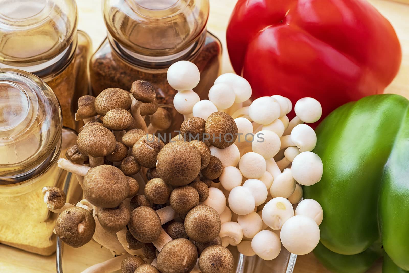 A set of sweet pepper and mushroom ingredients on a wooden boardWhite beech mushrooms or Shimeji mushroom . Small white and brown mushrooms on the table.