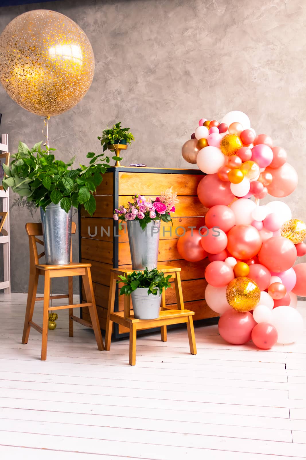 On the wooden surface laid out tools for flower bouquets: scissors, roses, colored ribbon, roses.