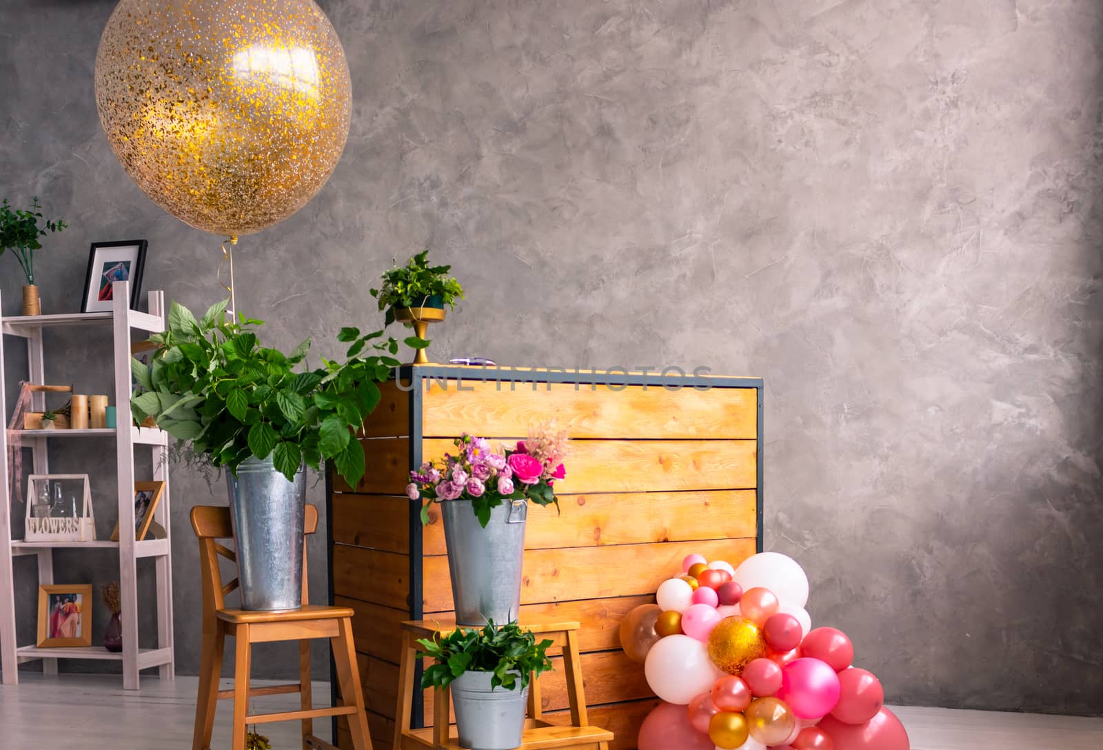 On the wooden surface laid out tools for flower bouquets: scissors, roses, colored ribbon, roses.