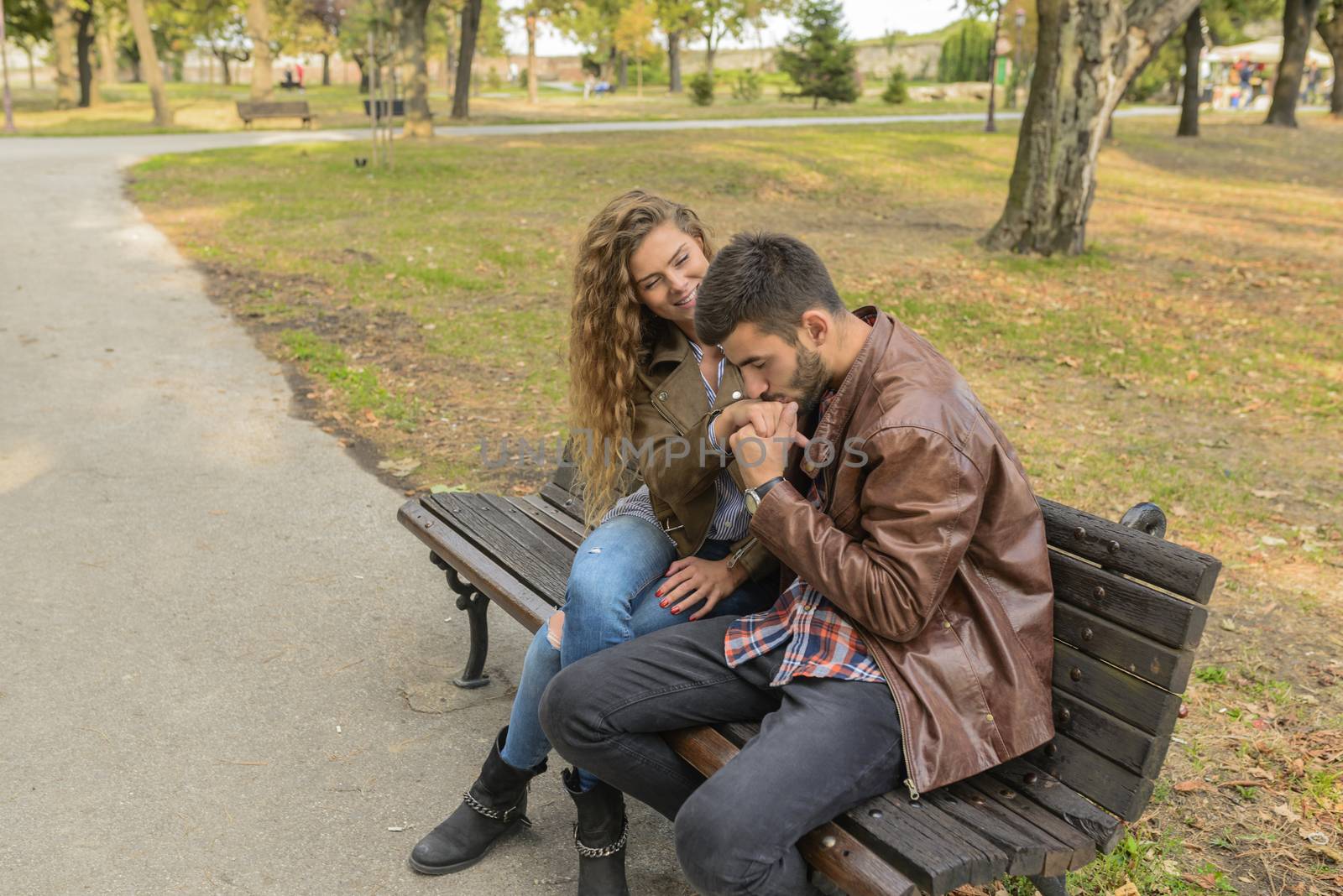 Handsome young man is kissing his girlfriends hand. Romantic moment