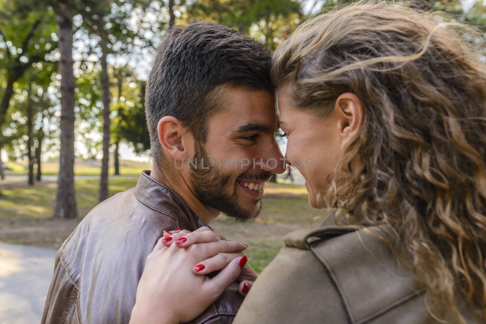 Romantic moments of young couple in the public park by VeraAgency