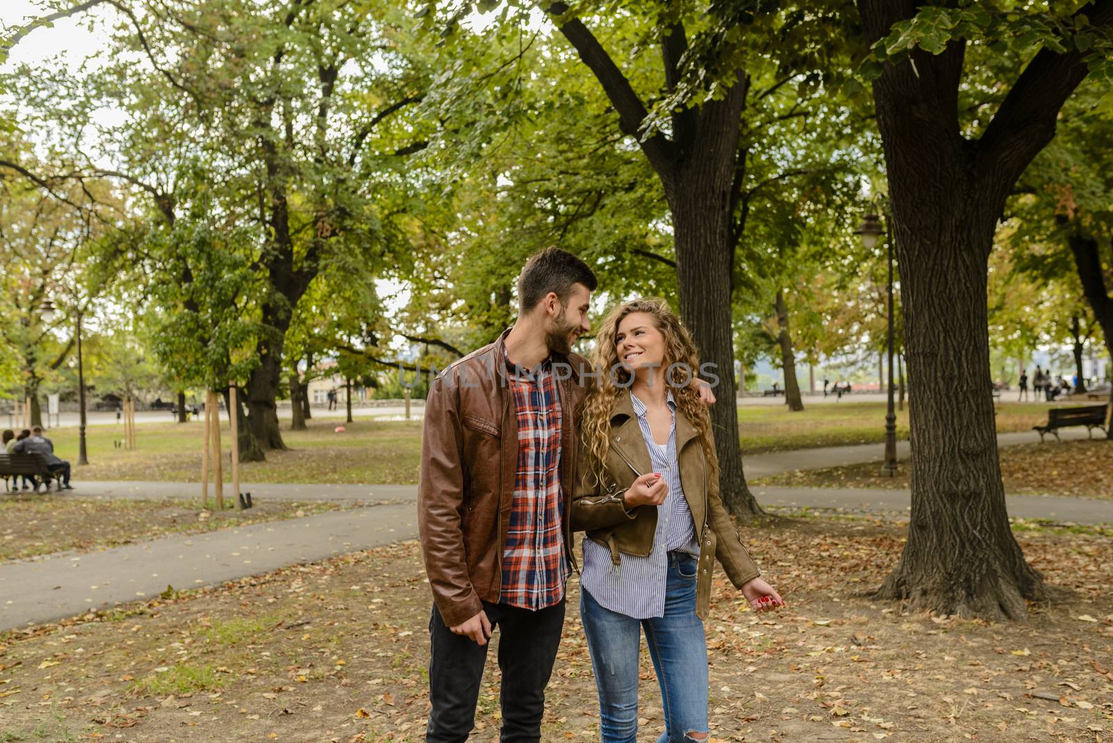 Modern couple enjoying the time in the city park by VeraAgency