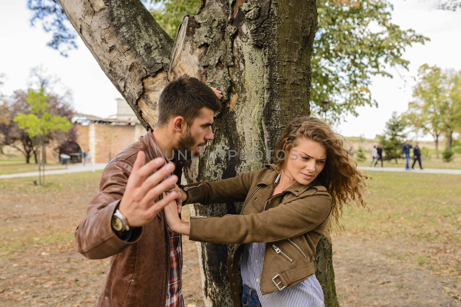 Young couple showing anger in the public park by VeraAgency