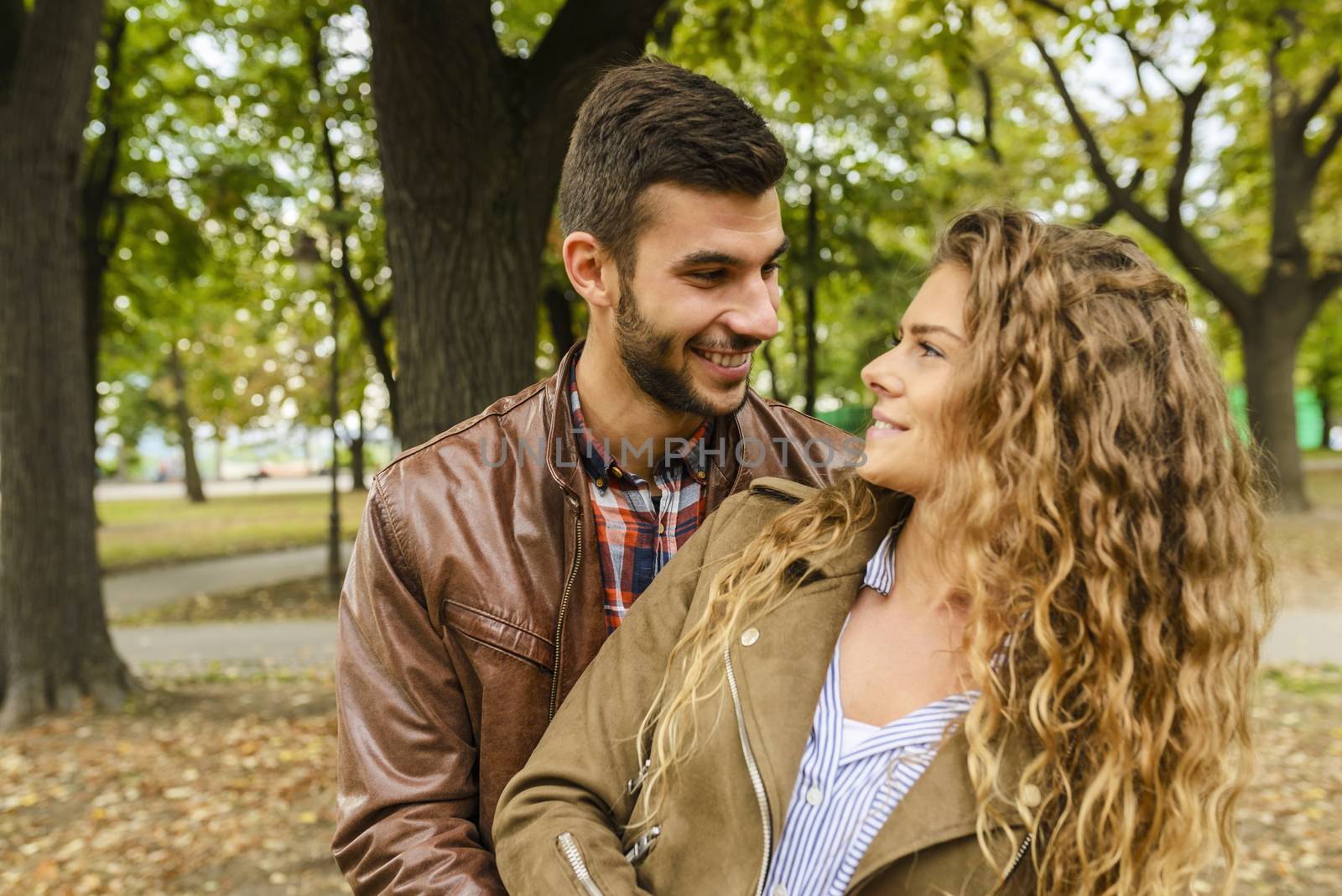 Young couple in the city park by VeraAgency