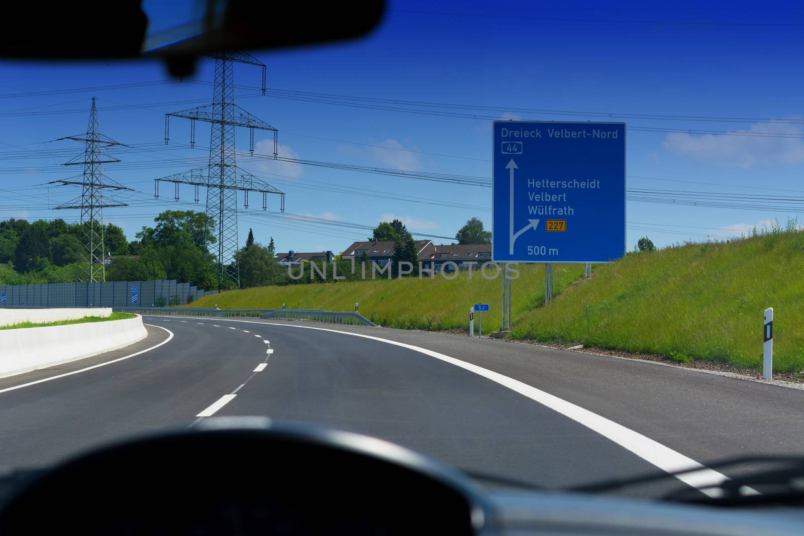 German motorway sign with inscription in German Driving direction to the cities - Velbert, Heiligenhaus, Wuelfrath and Hetterscheidt