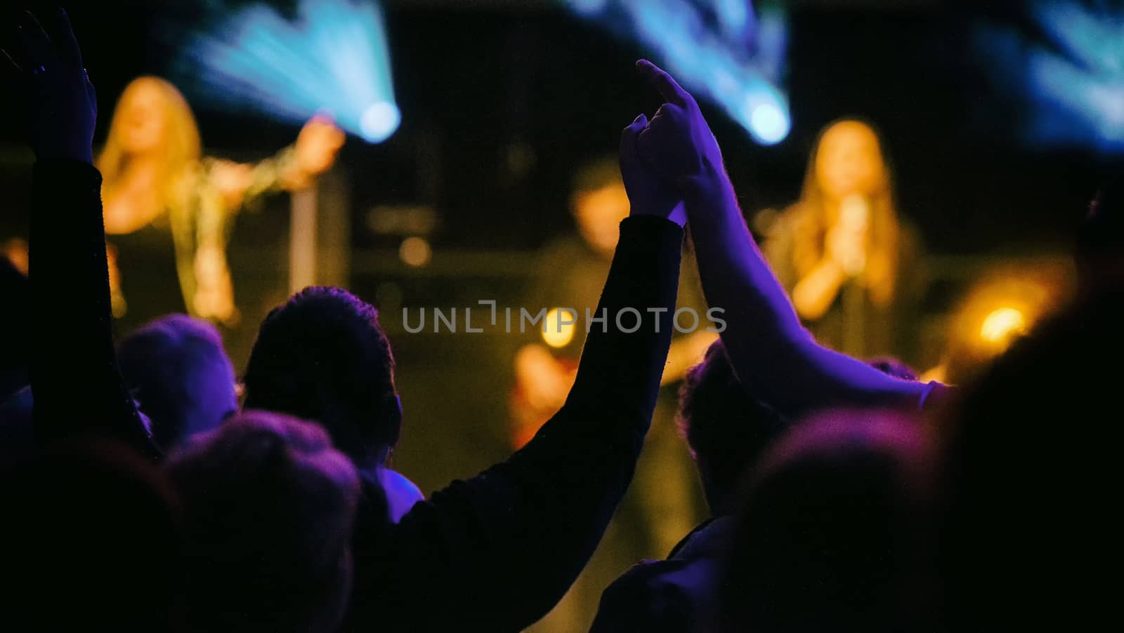 Eindhoven,netherlands,26-jan-2019:loving couple with hands strangled en up having fun while listening to the music on stage during a concert,this is a annual concert with different artists