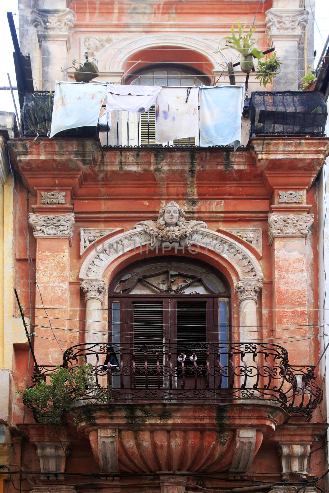 Hanging laundry to dry on balcony in Havana, Cuba