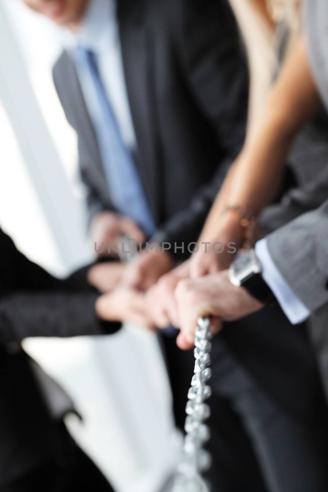 Business people team pulling steel chain together
