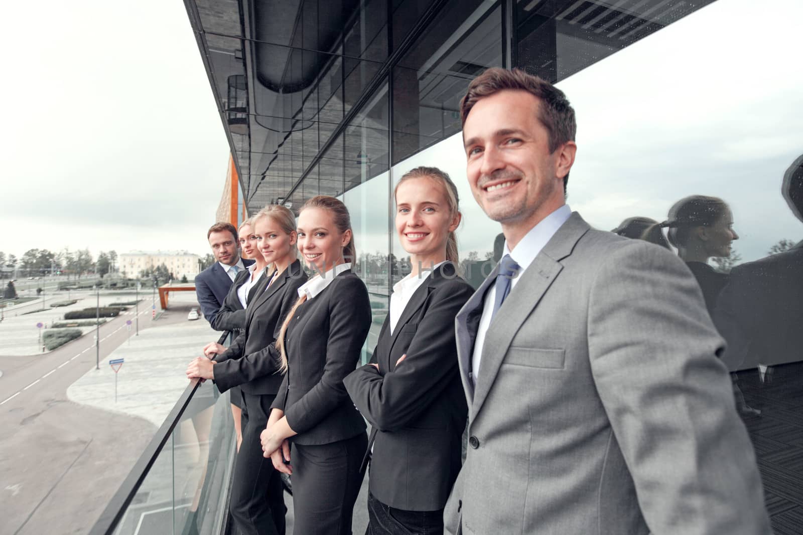 Business people team standing in a row at the balcony of modern office building