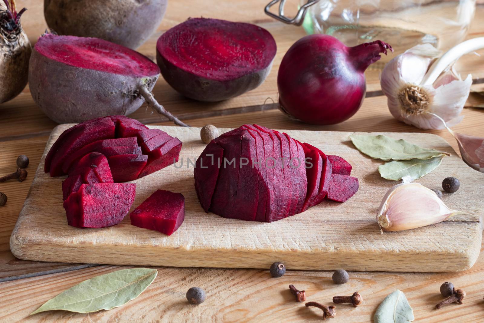 Sliced red beets with garlic and spices on a table