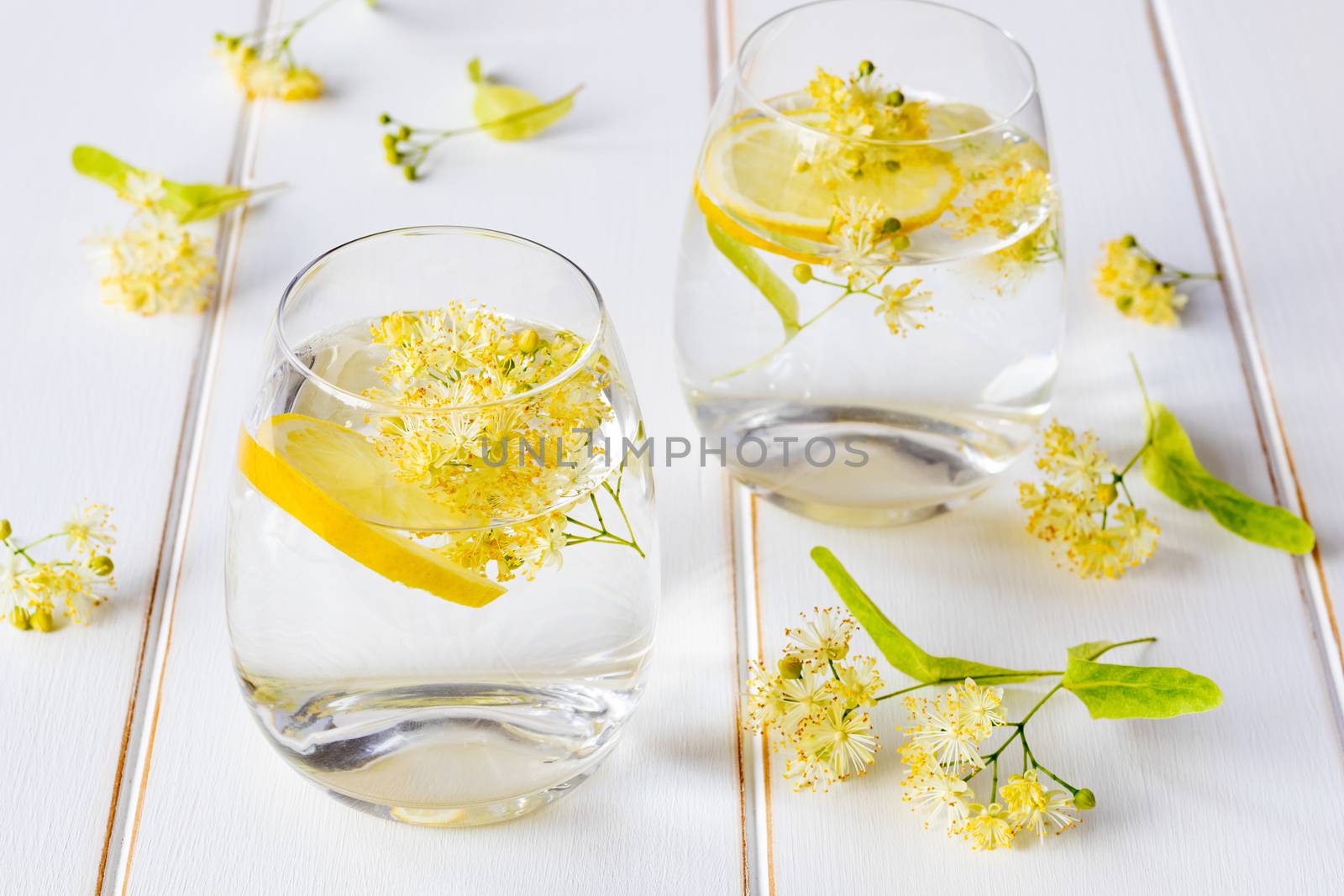 Linden lemonade and flowers on a white background