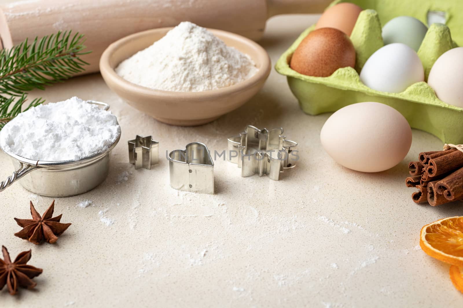 Ingredients for Christmas baking on a beige background with copy space