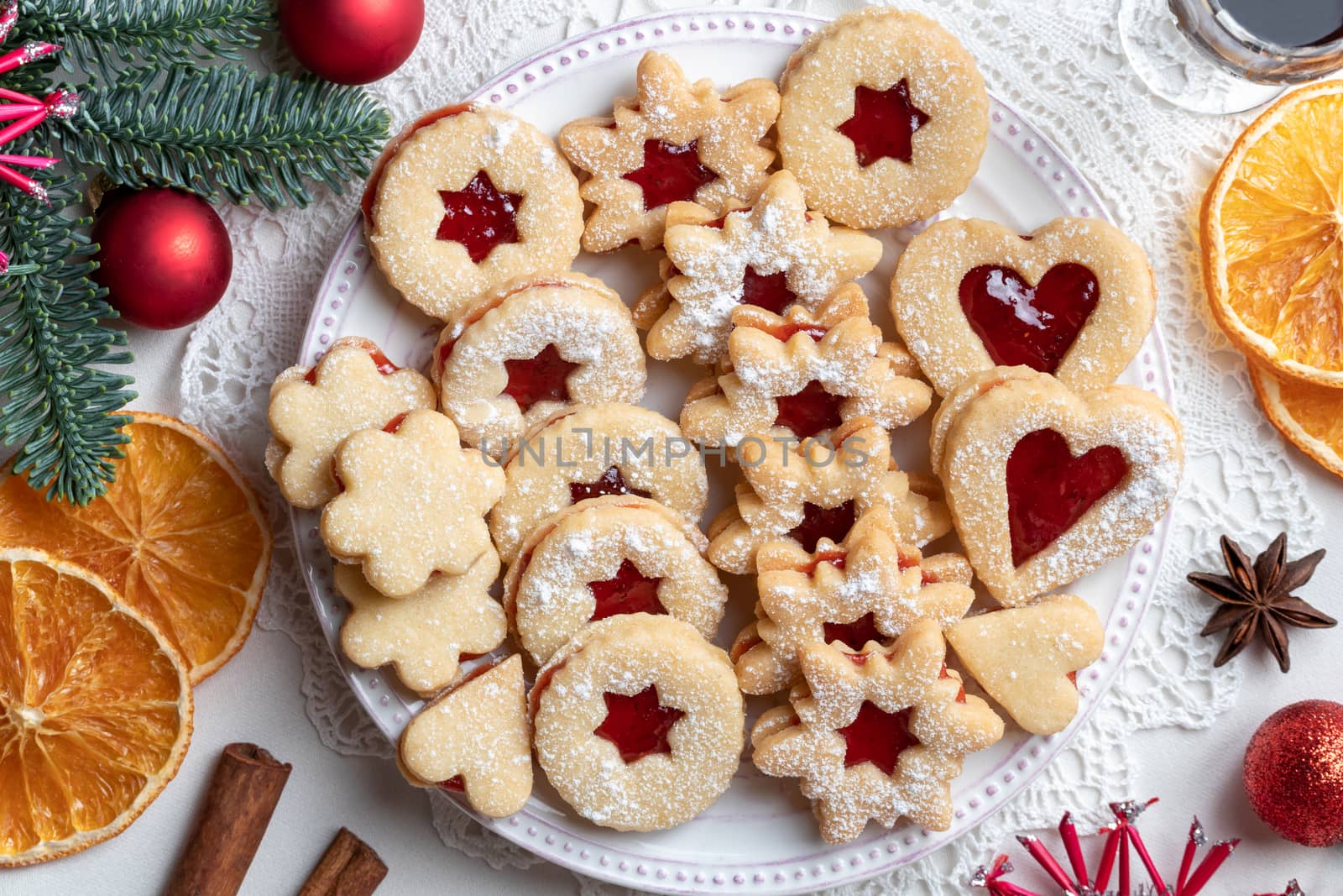 Traditional Linzer Christmas cookies filled with strawberry jam and dusted with sugar, top view