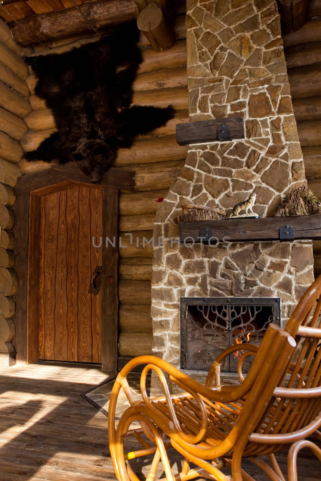 country style interior in hunter chalet with fireplace.