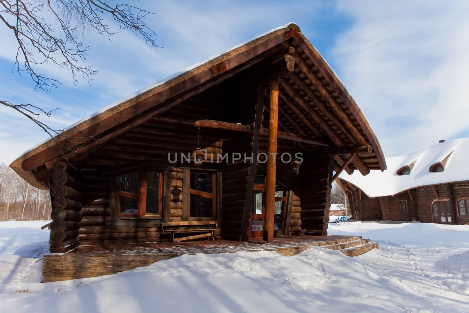 beautiful chalet of wooden frame in the winter landscape