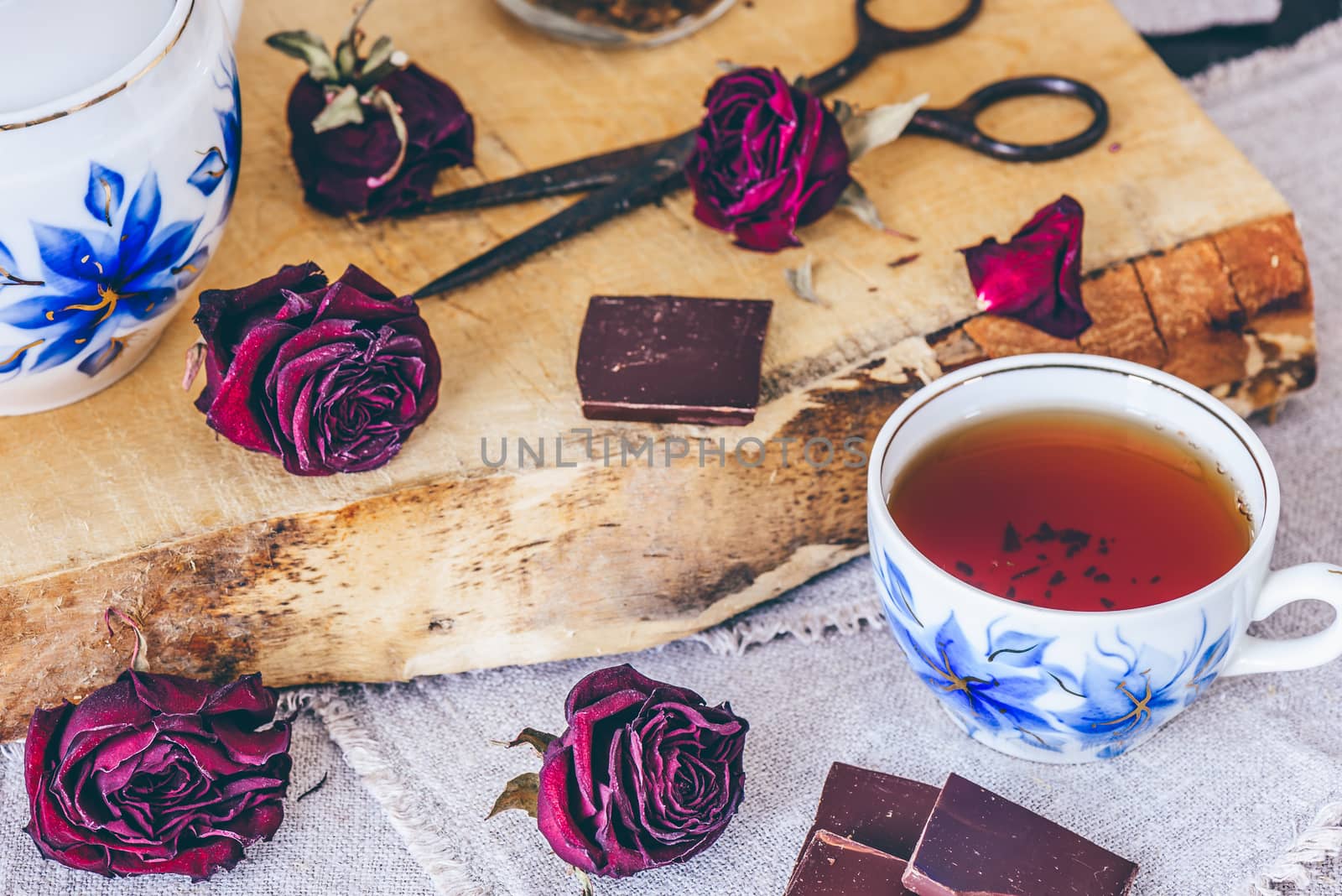 Cup of Tea.with Dry Roses Buds and Chocolate.