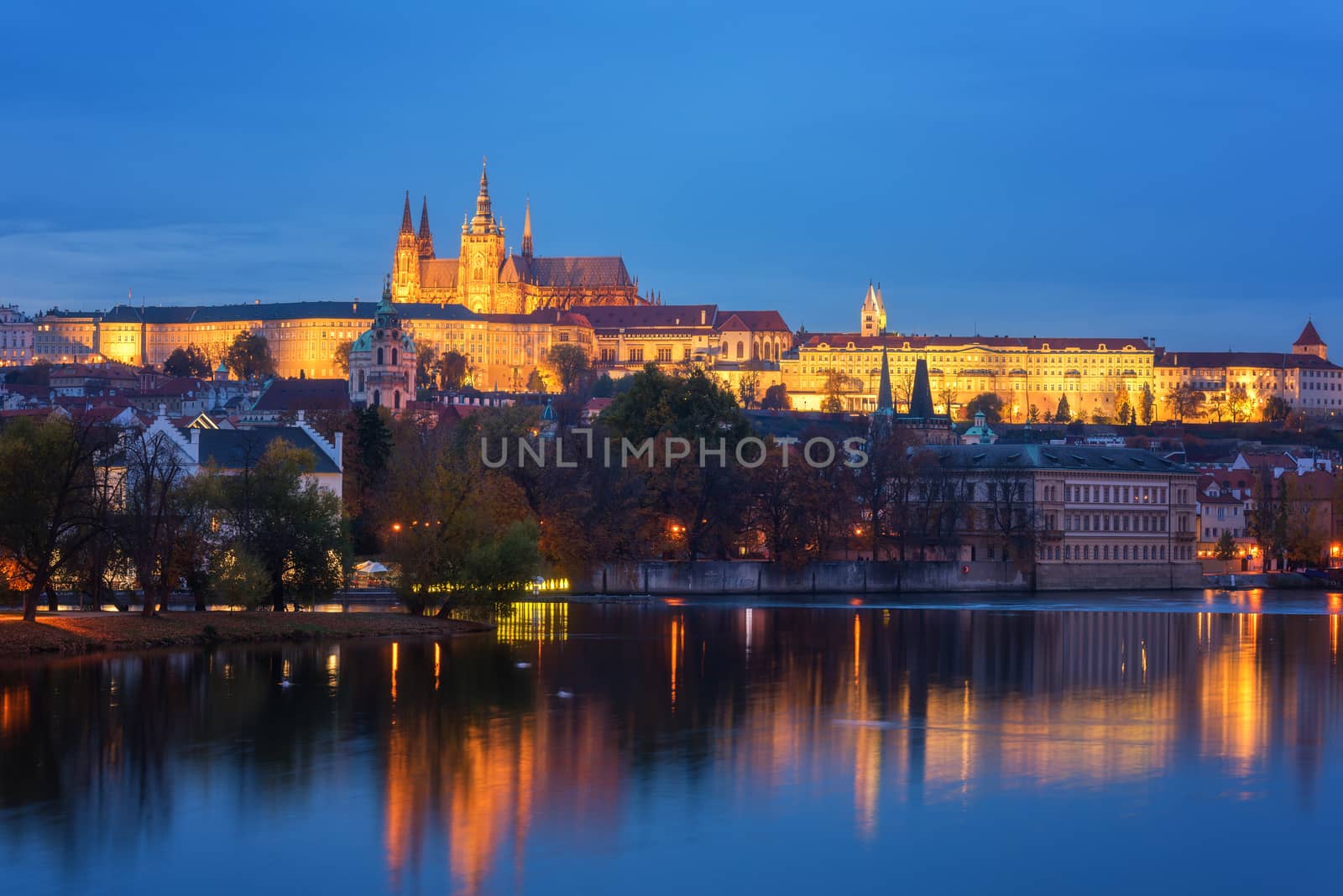 Prague, view of illuminated Prague castle (Prazsky Hrad) with reflection in the water, night scenic cityscape, Czech Republic by LaraUhryn