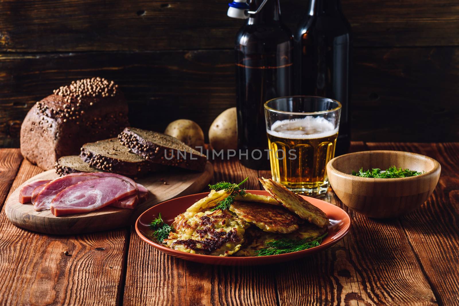 Glass of Beer with Potato Pancakes, Smoked Meat and Rye Bread.